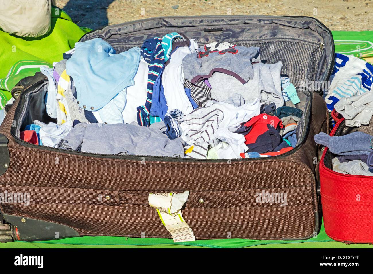 Suitcase opened after coming home from a holiday with clothes packed inside Stock Photo