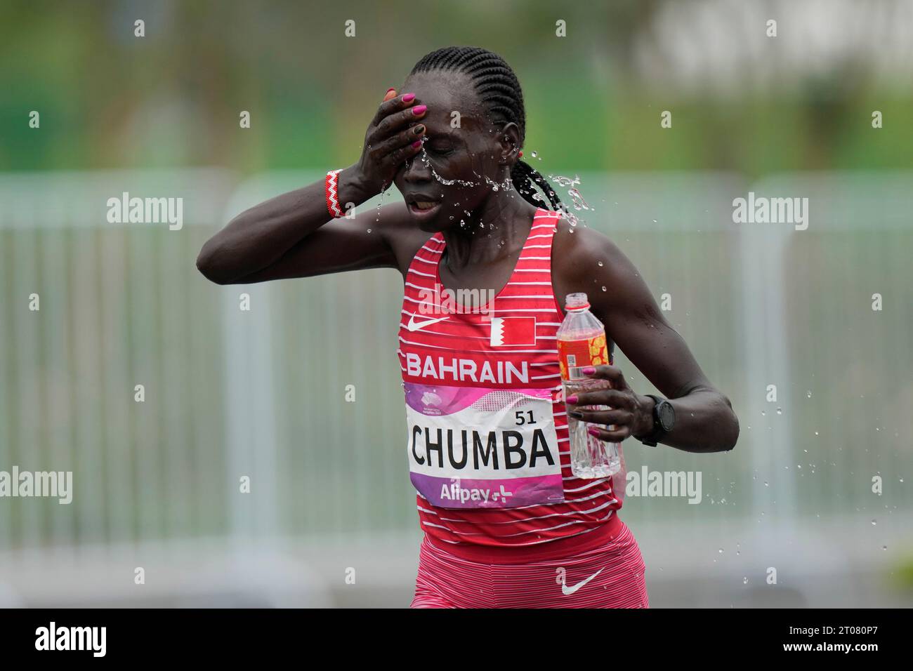 Bahrain's Eunice Chebichii Paul Chumba cools herself as she competes in