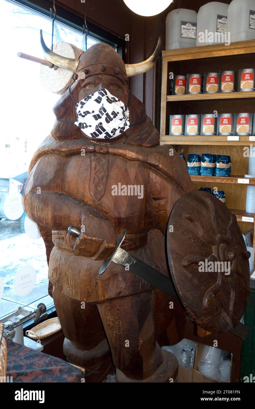 Masked wooden sculpture of a Viking warrior in Ingebretsen's Scandinavian Gifts & Foods Shop during the Covid Pandemic. Minneapolis Minnesota MN USA Stock Photo