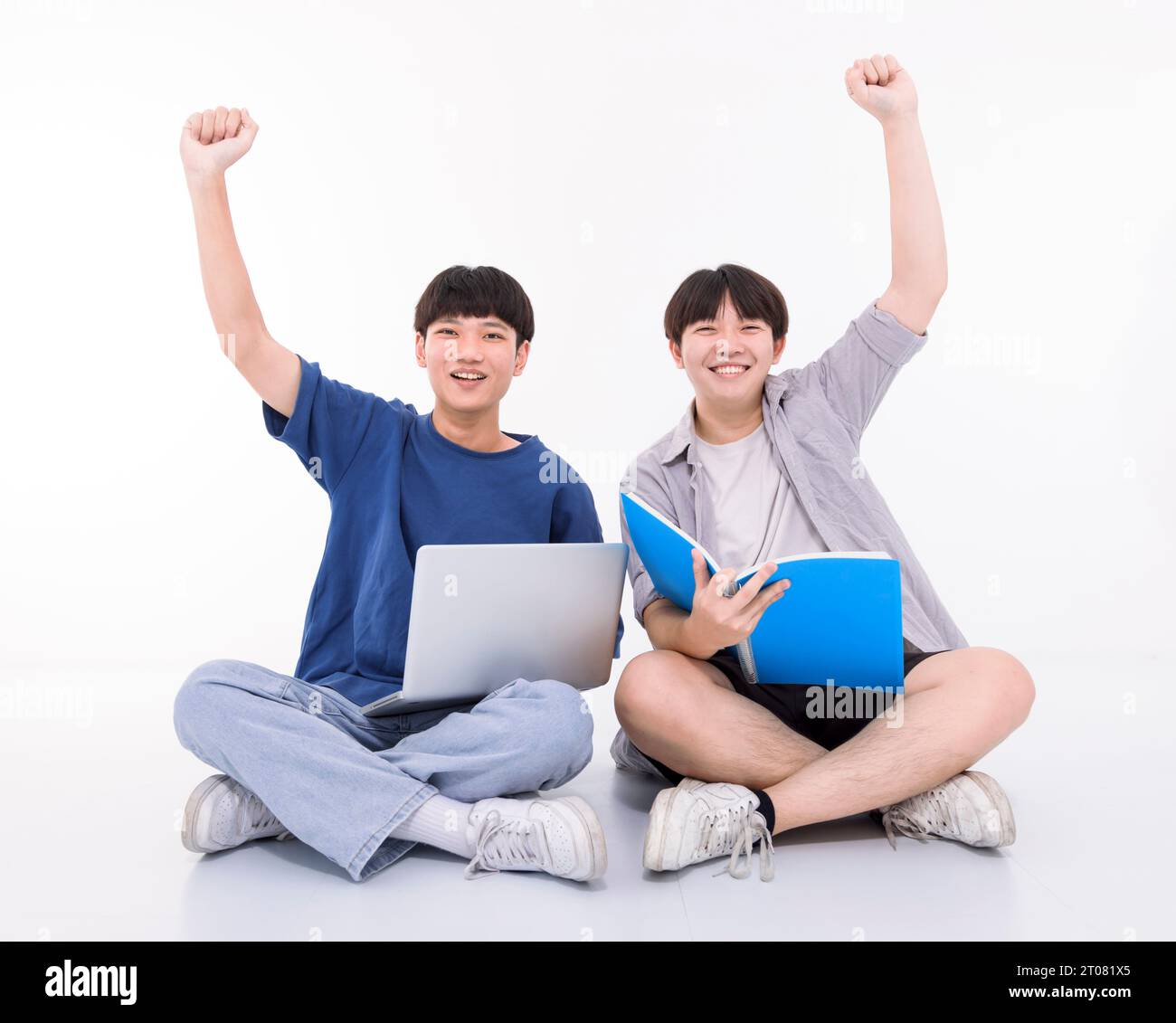 Two smart teenager students  celebrating their test score together. Stock Photo