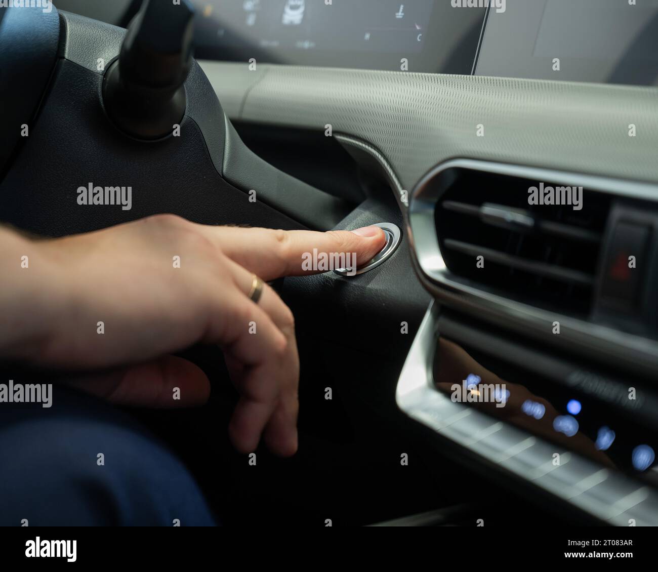 A man presses the car engine start button Stock Photo - Alamy