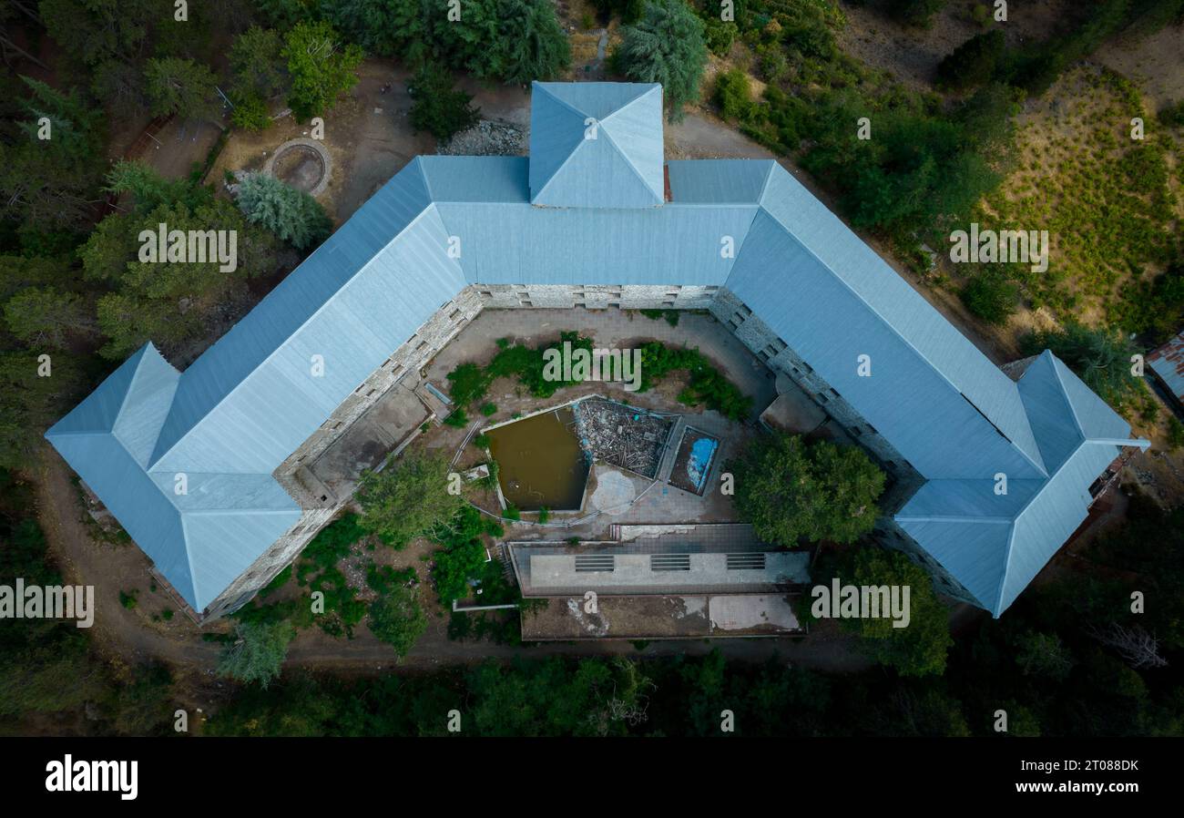 Drone aerial of an abandoned hotel building in the forest. Deserted ...