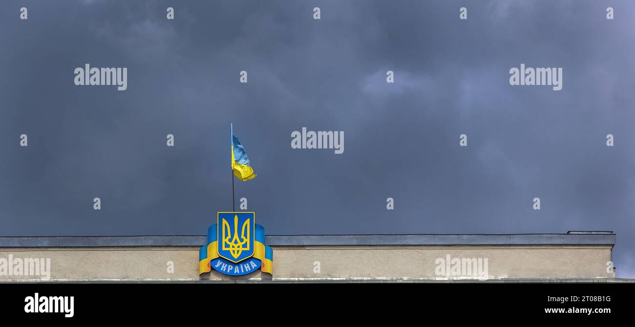 flag and coat of arms of Ukraine on sky background Stock Photo