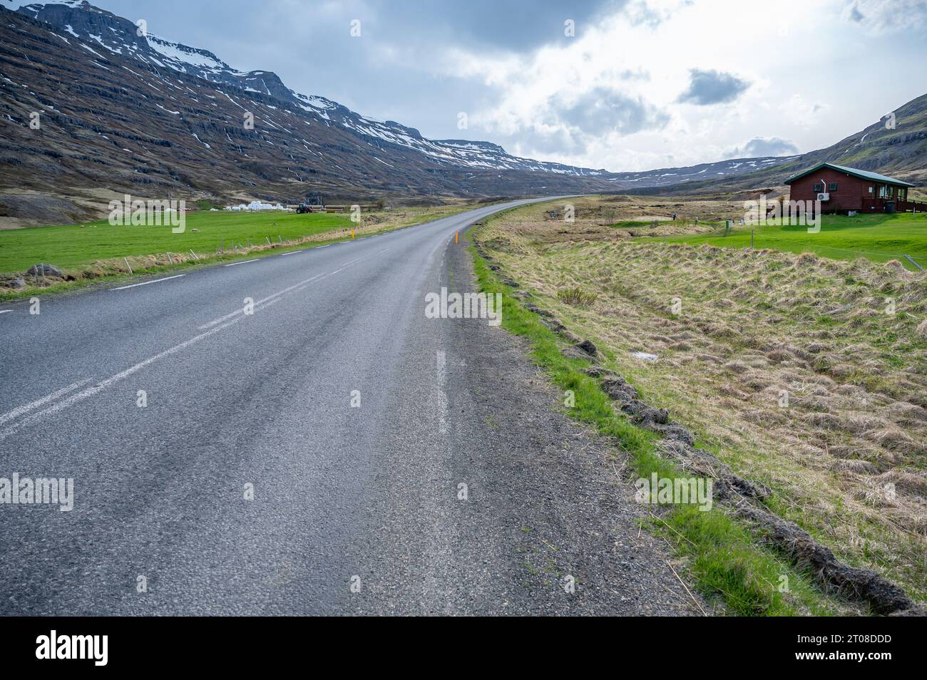 Road going to Gufufoss waterfall from Seydisfjordur, Iceland, beautiful landscape and snow mountain range, wide angle shot Stock Photo