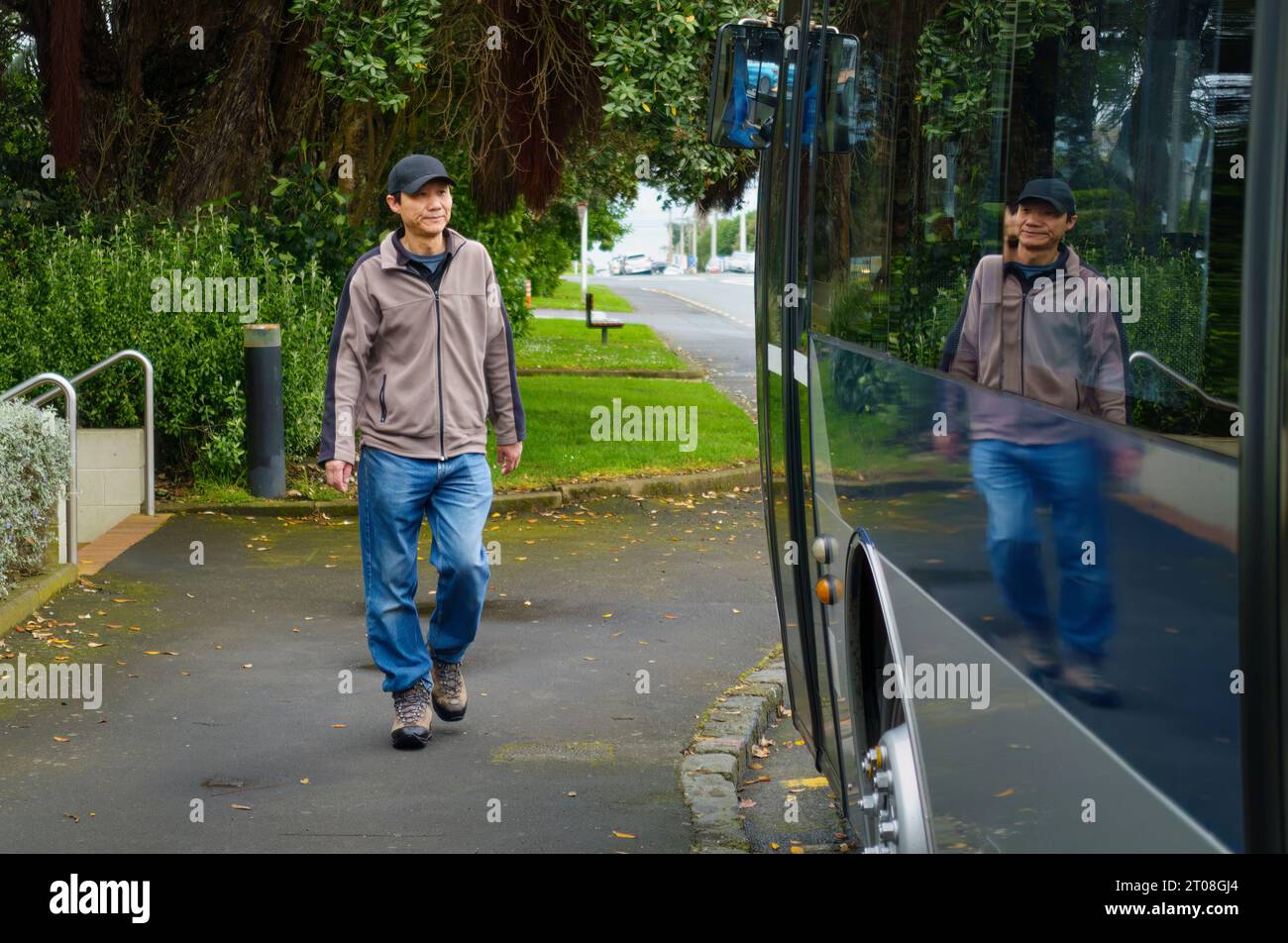 Man walking to the bus stop. Stock Photo