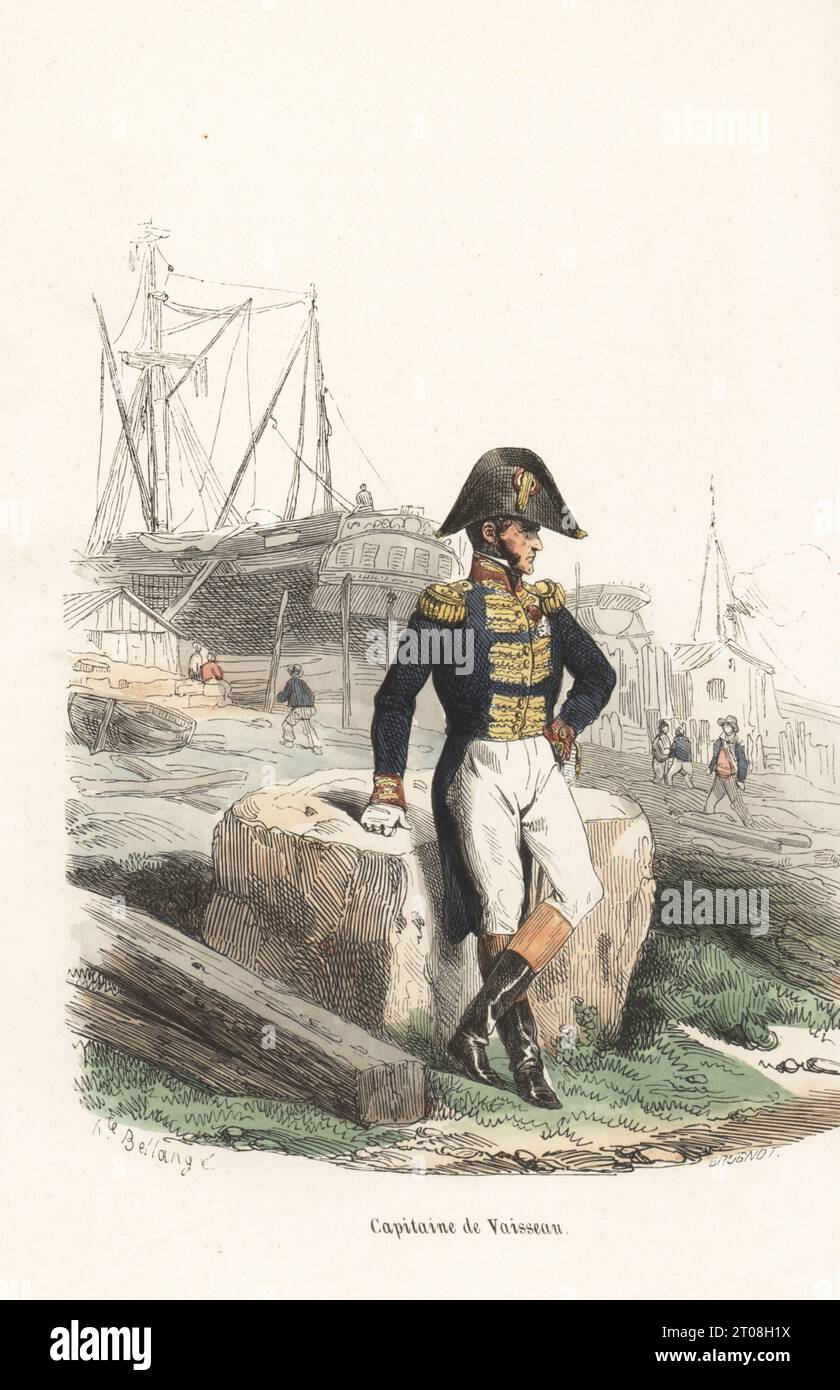 Uniform of a French naval captain, Napoleonic era. In bicorne with cockade, tailcoat with gold epaulettes and frogging, breeches and boots. On a shore in front of a ship. Capitaine de Vaisseau. Handcoloured woodcut by Brugnot after an illustration by Hippolyte Bellangé from P.M. Laurent de l’Ardeche’s Histoire de Napoleon, Paris, 1840. Stock Photo