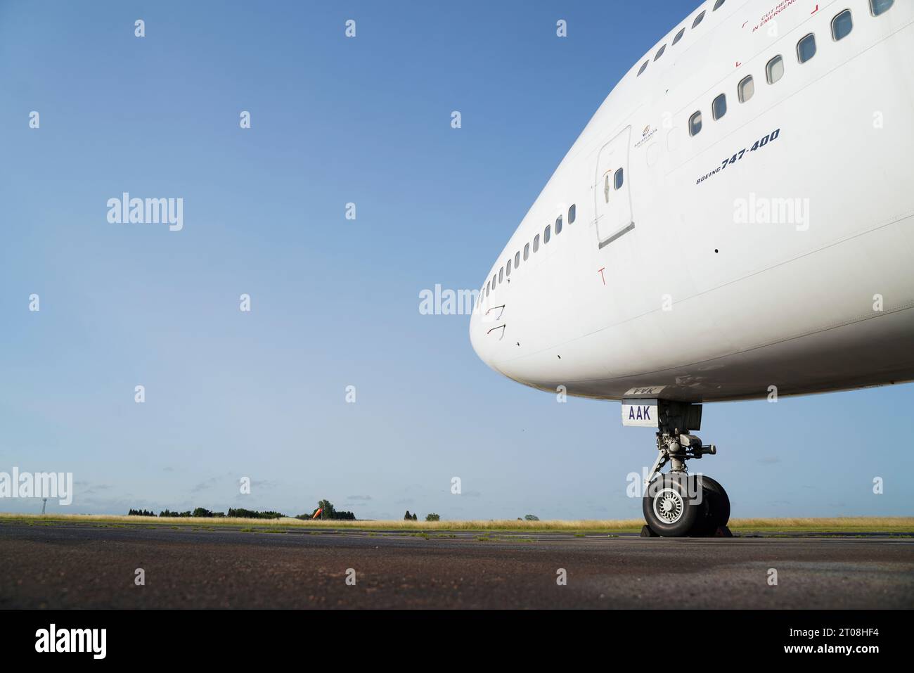 A Boeing 747-400 jumbo jet against a blue sky on a runway in Kemble, Gloucestershire, UK Stock Photo
