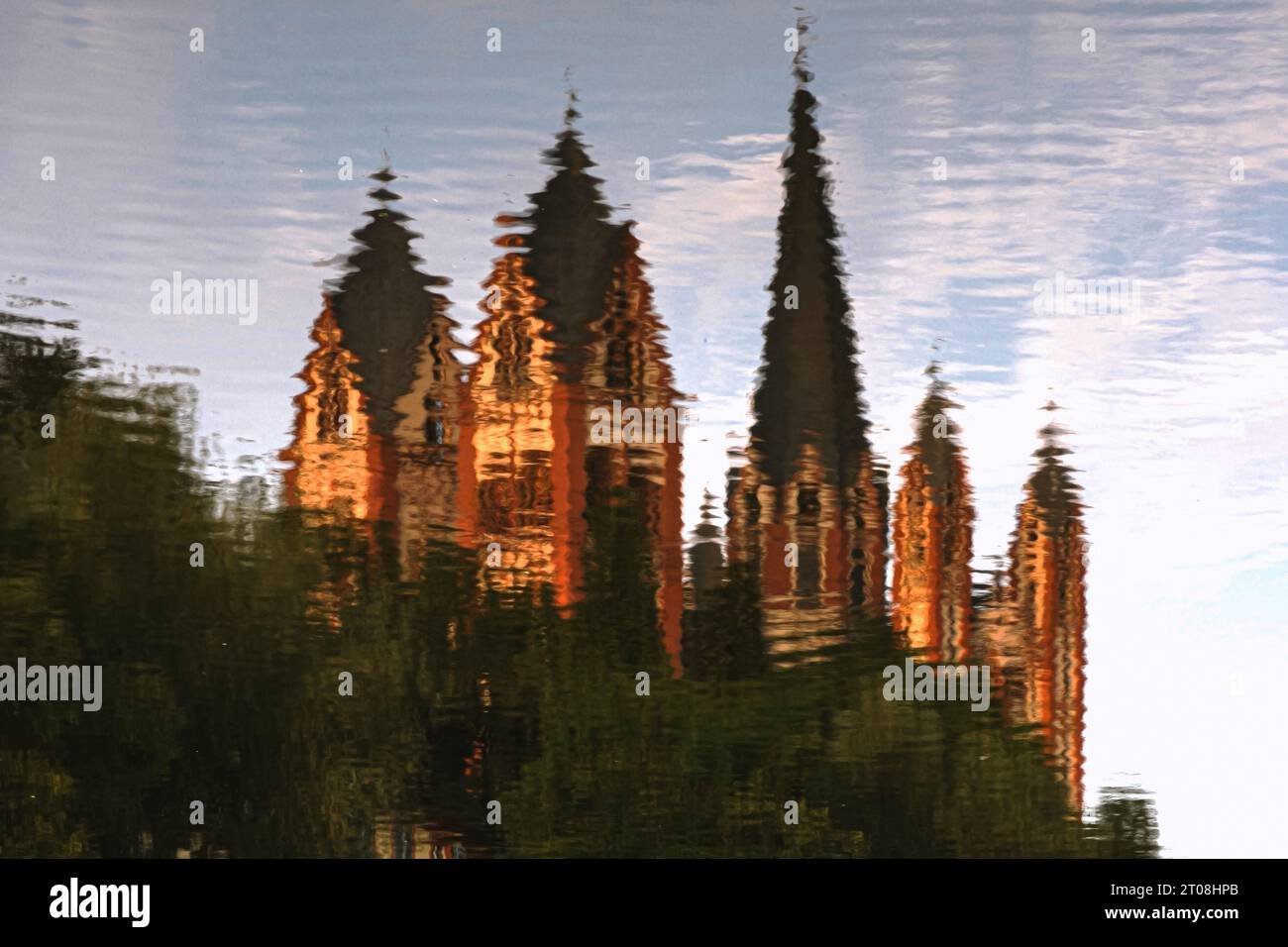 Reflection in the River Lahn of Late Romanesque / Early Gothic Cathedral of Saint George at Limburg an der Lahn, Hesse, Germany, built late 1100s / early 1200s. The cathedral, with seven towers of varying heights, including one with a slightly curving spire, used to feature on pre-Euro Deutsche Mark banknotes. It owes its exuberant and colourful exterior to painstaking restoration work in the 1960s and ‘70s, with colours determined by traces of original paint. Stock Photo