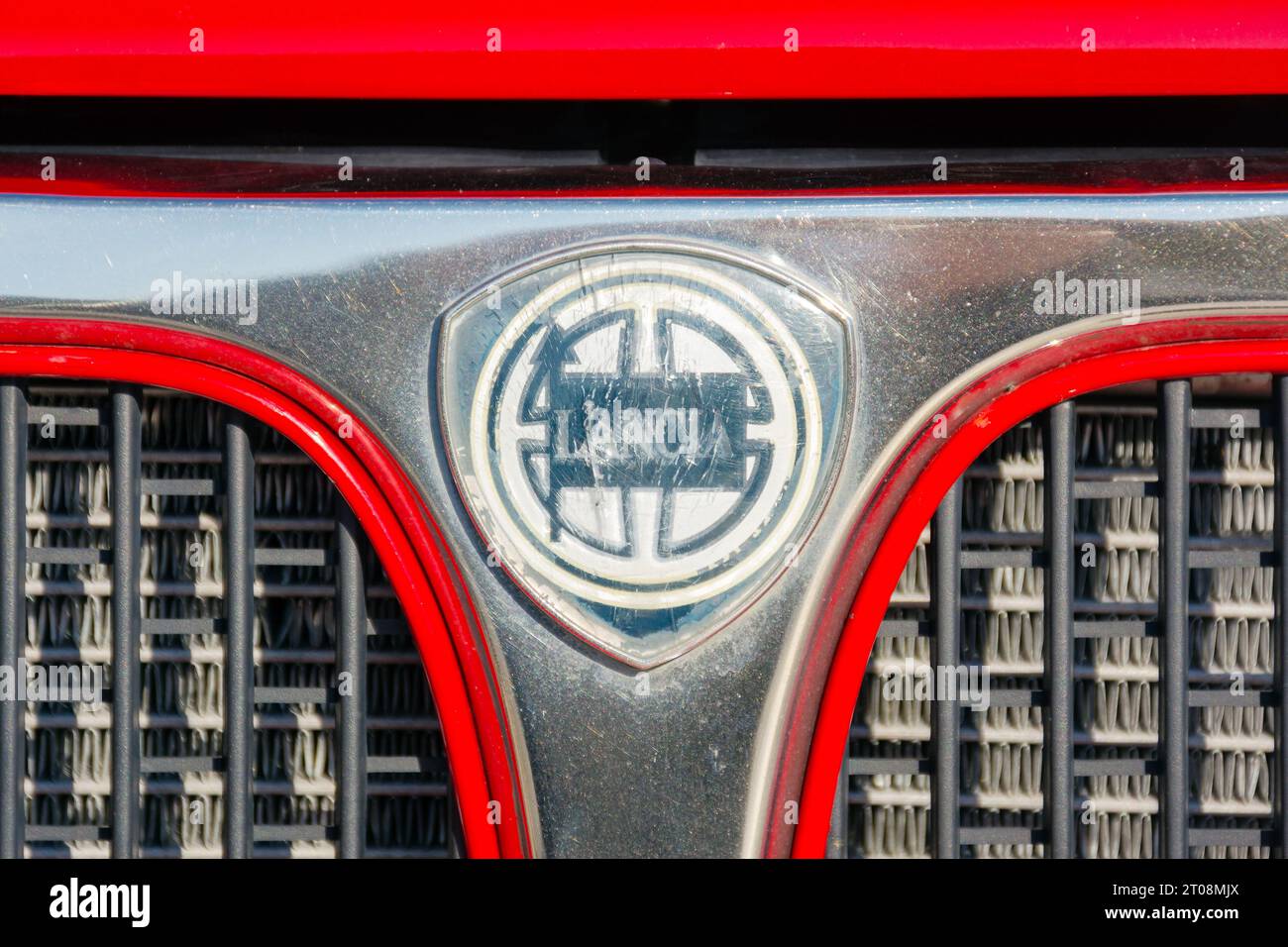 shabby lancia hood ornament on the grill of a legendary rally car. vehicle of a red color Stock Photo
