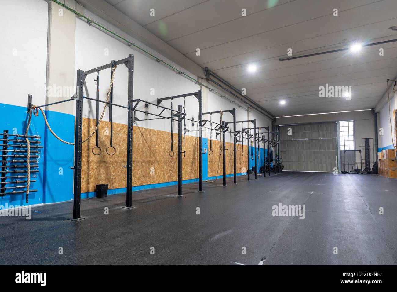 Empty space of a cross training room with bars and Olympic rings Stock