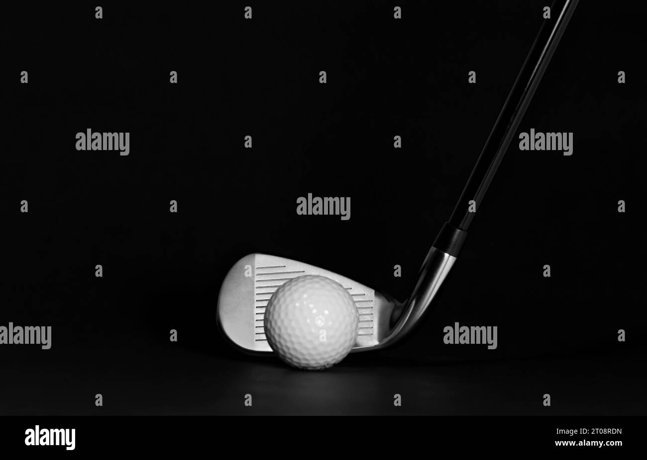 Golf Club Iron and Ball pictured on a Black Background with Surface