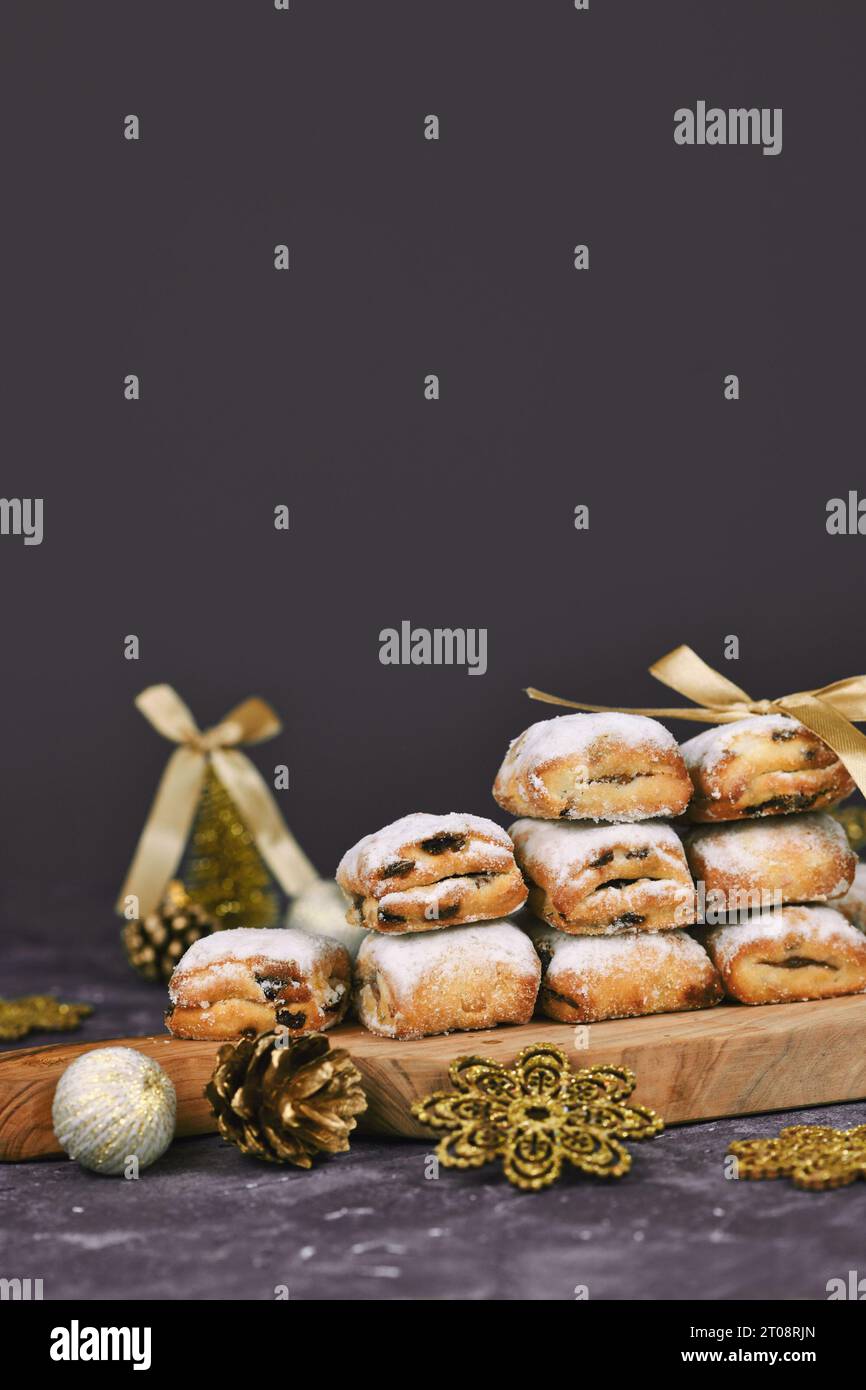Stollen cake pieces, a small German fruit bread with nuts, spices, and dried fruits with powdered sugar traditionally served during Christmas time Stock Photo