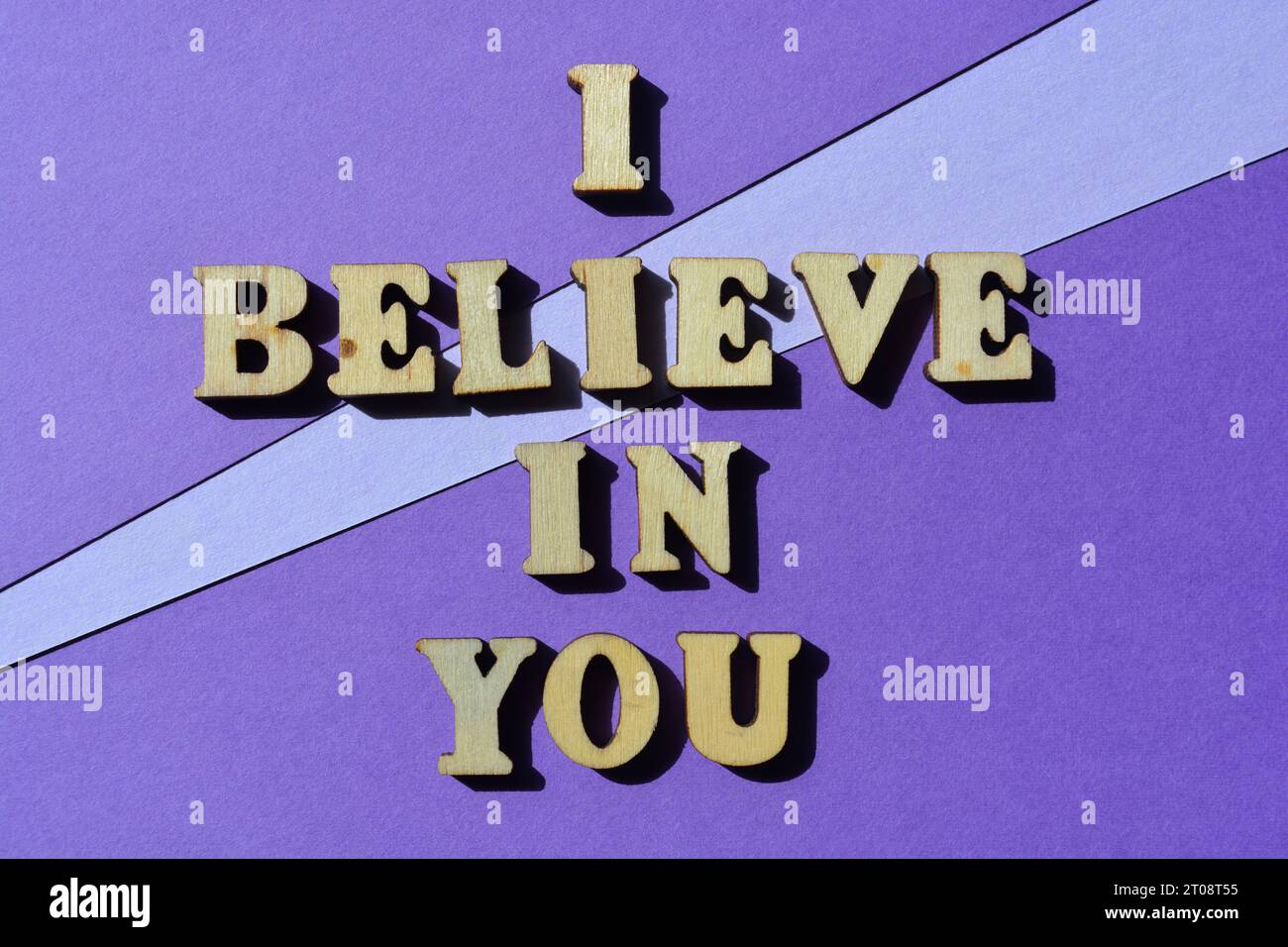 I Believe In You, words in wooden alphabet letters isolated on purple background as banner headline Stock Photo