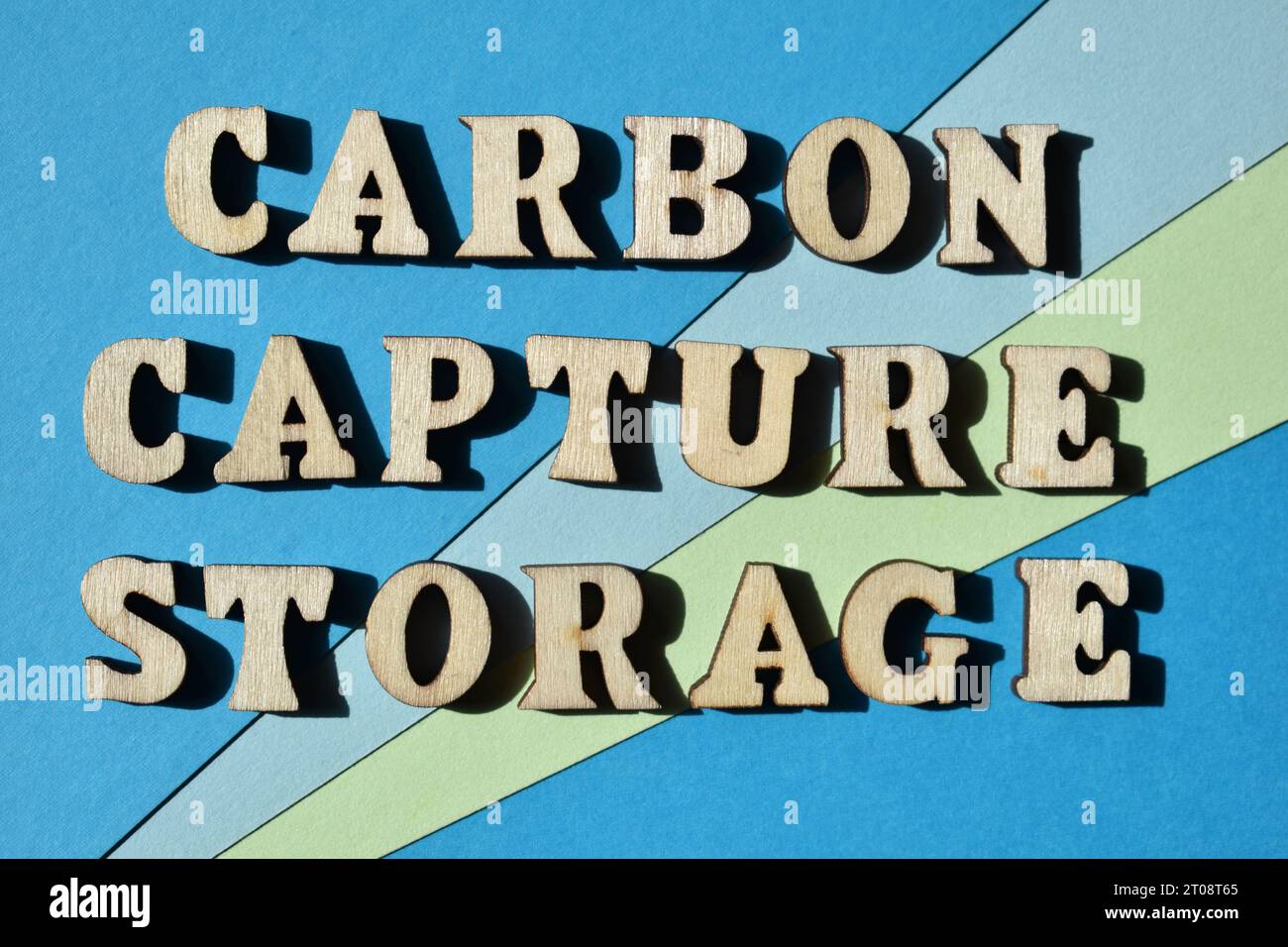 Carbon Capture Storage, words in wooden alphabet letters isolated on blue and green background as banner headline Stock Photo