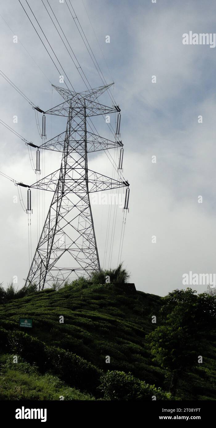 High voltage power line on the mountain with blue sky and white clouds ...