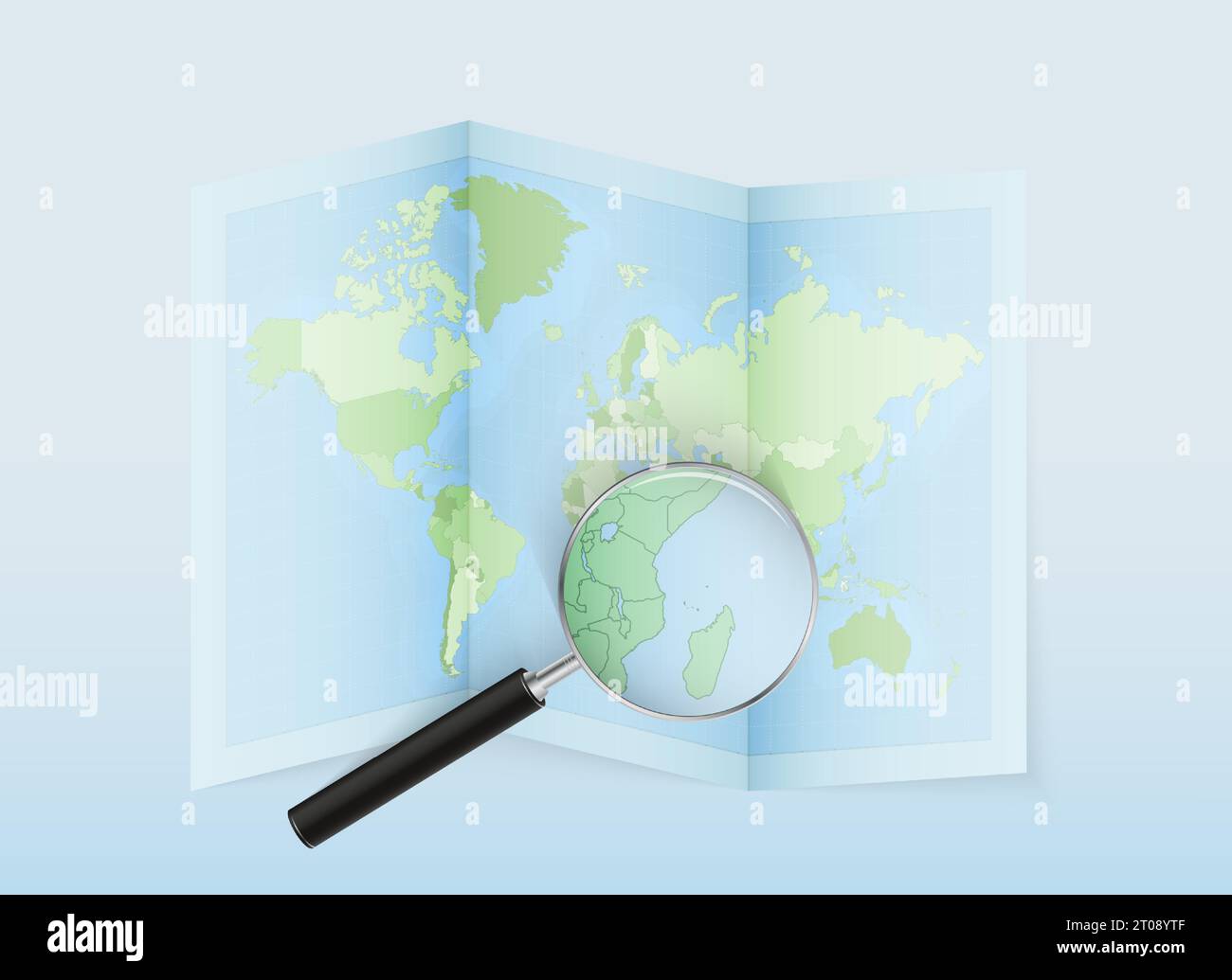 A folded world map with a magnifying lens pointing towards Comoros. Map