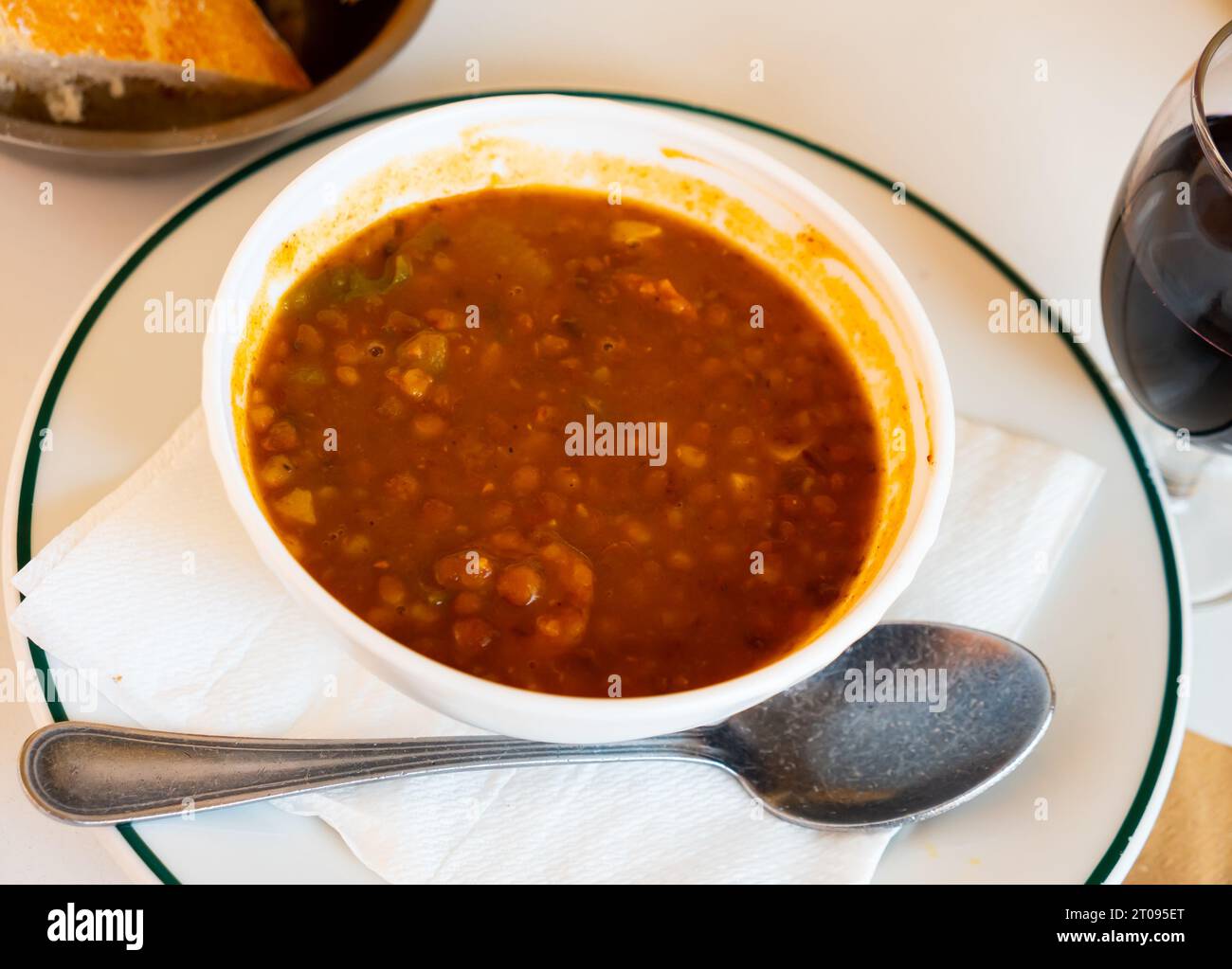 Stewed lentils with suasage and vegetables with thick tomato sauce