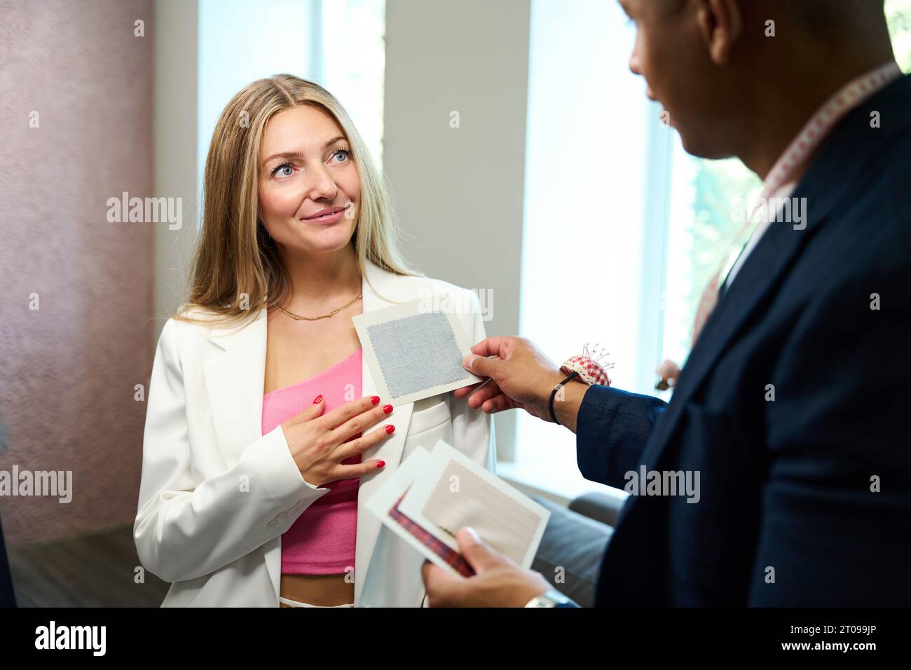 Fashion designer choosing appropriate sewing fabric for client Stock Photo