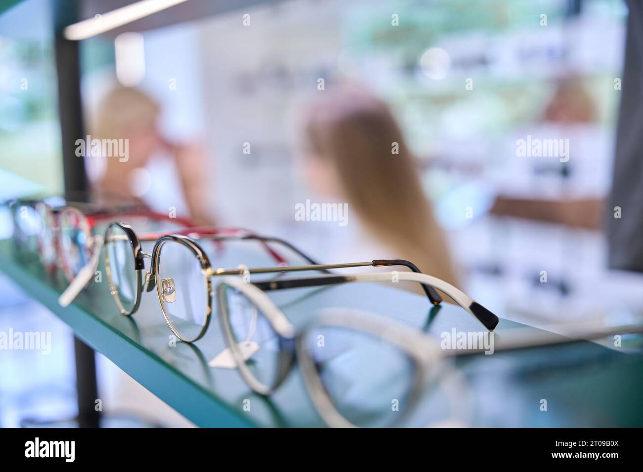 Consultant selects frames for a client Stock Photo - Alamy