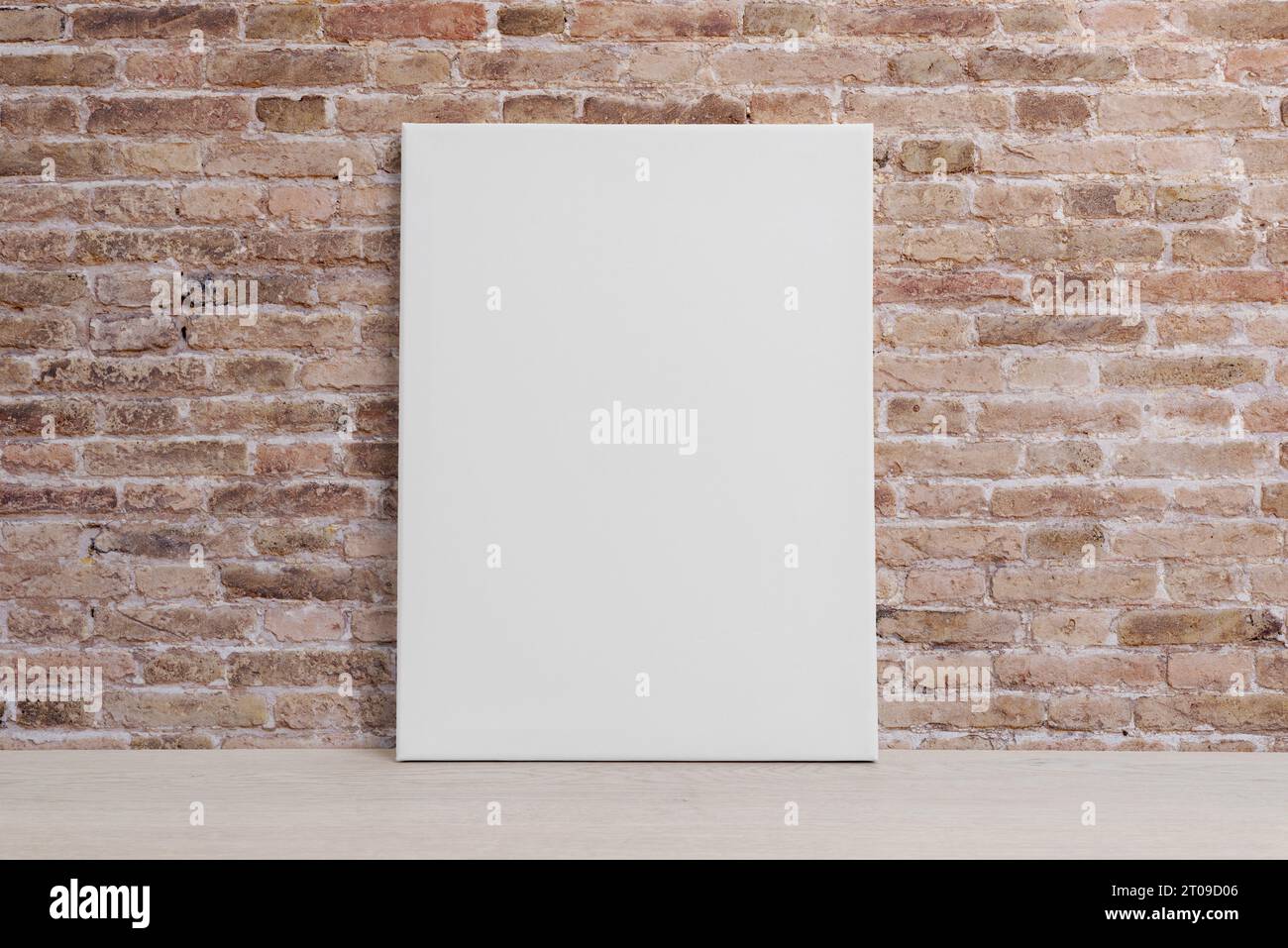 Blank art canvas leaning against the brick wall. Clean surface for mockup, art presentation Stock Photo