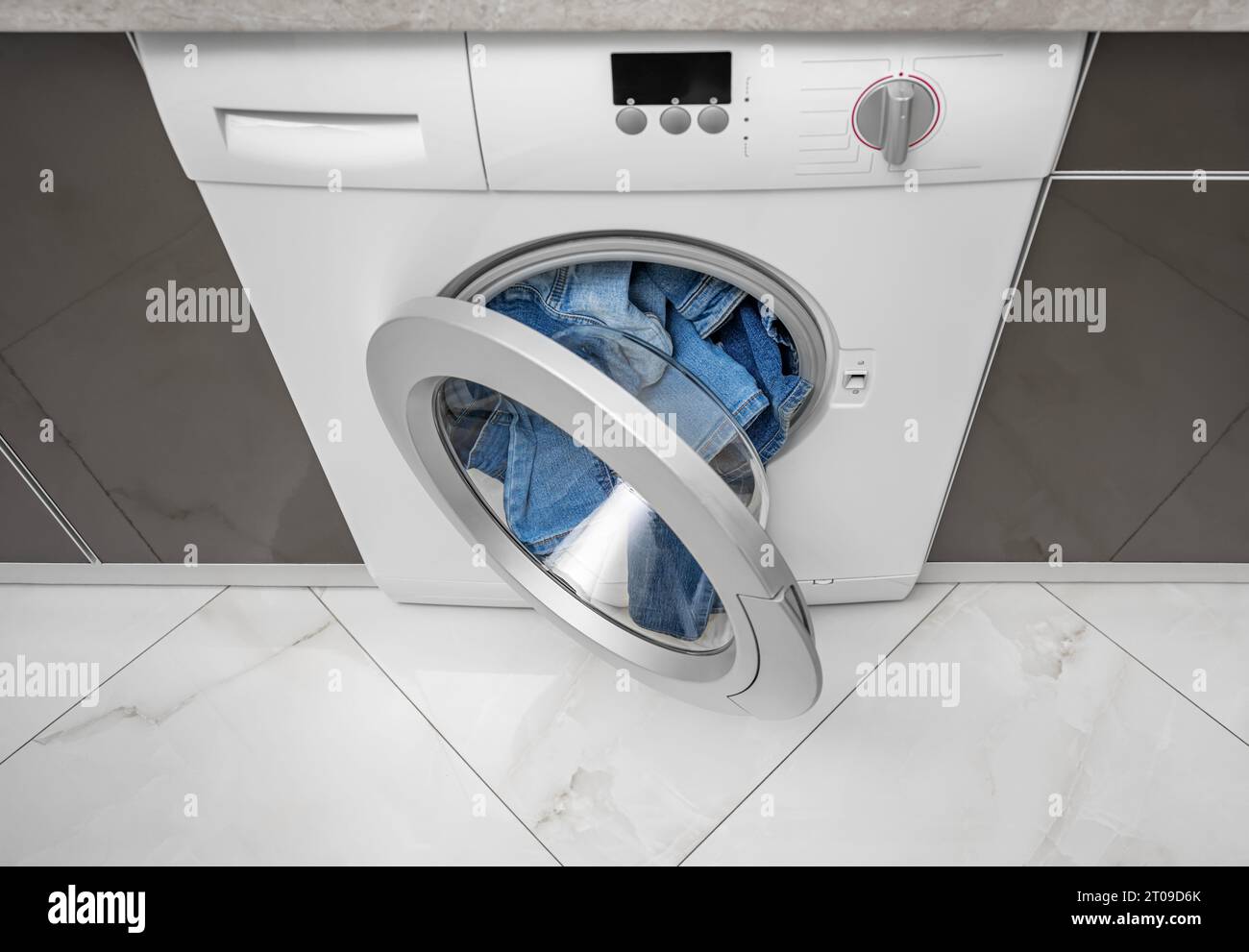 Washing machine overflowing with clothes Stock Photo Alamy