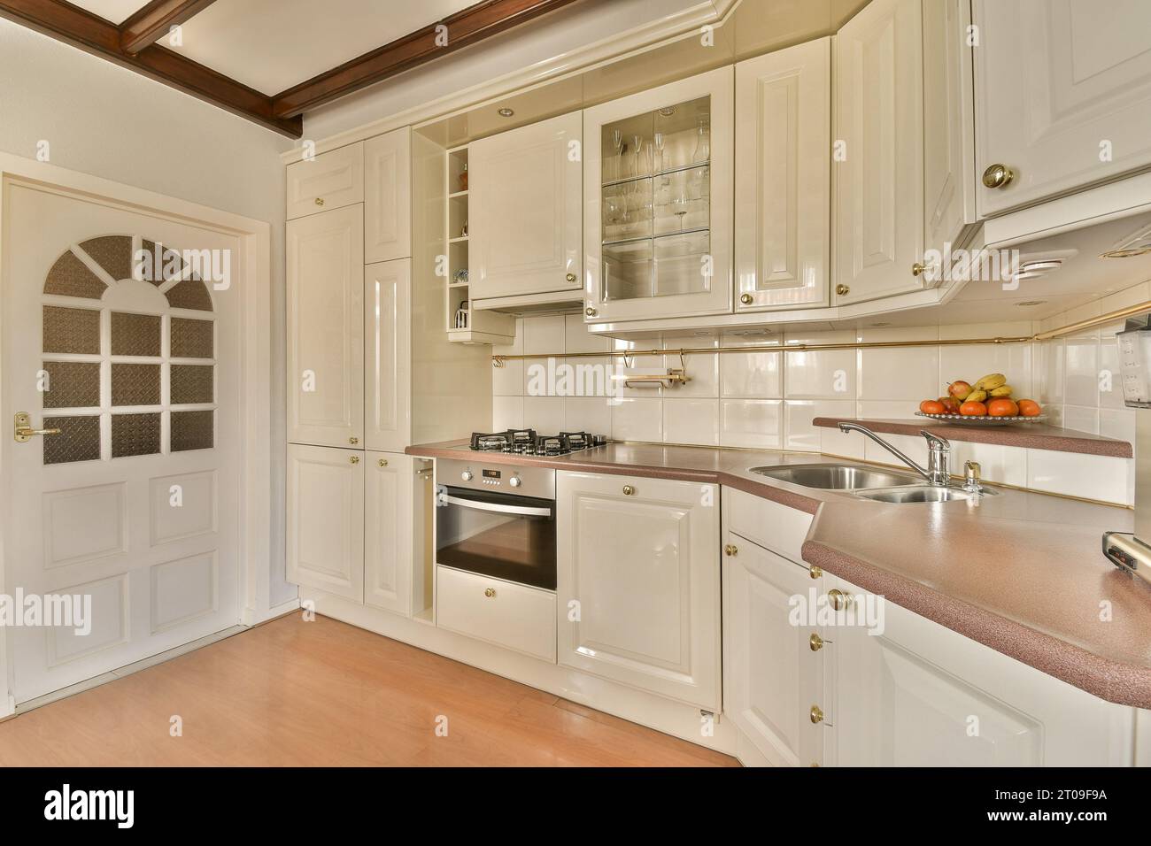 Interior of modern open plan kitchen with white cabinets and stainless ...