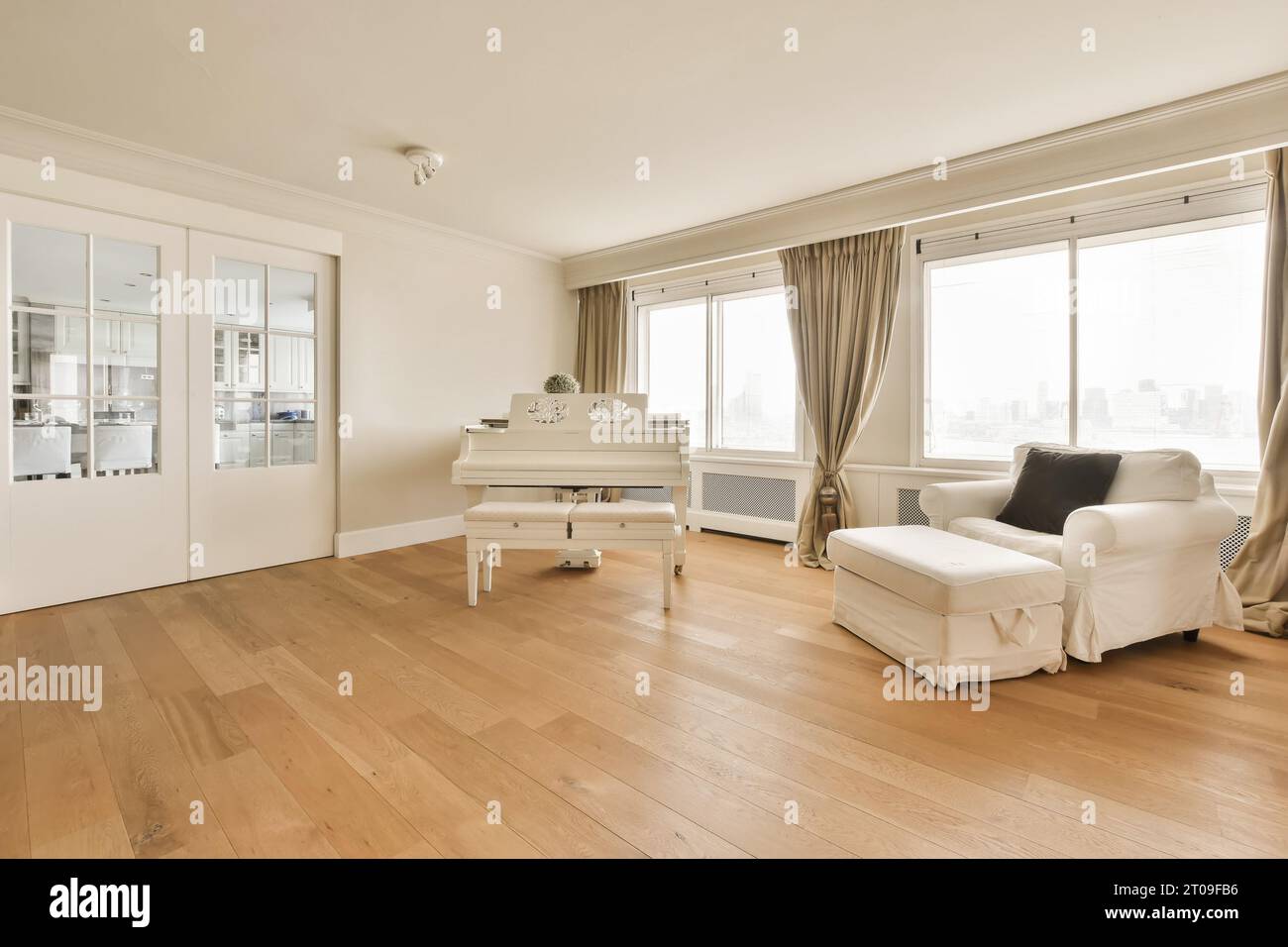 Interior of spacious living room with grand piano and large chair by ...