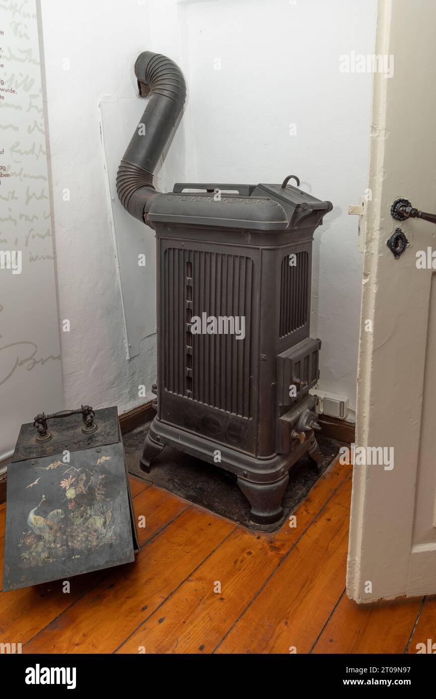 Historic cast iron wood and coal stove, 18th century. Wilhelm Busch Mill in Ebergötzen, Germany Stock Photo