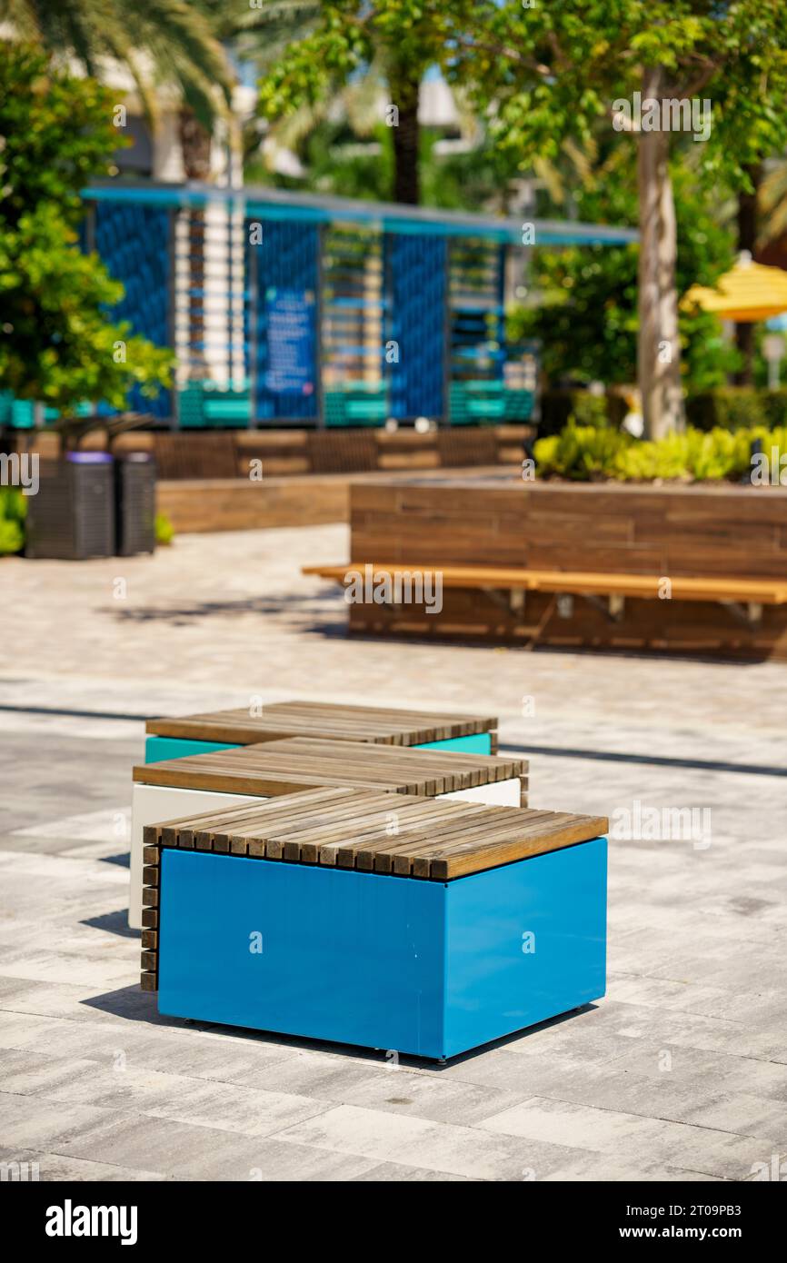 Modern patio furniture in an open air promenade. Blurry bokeh