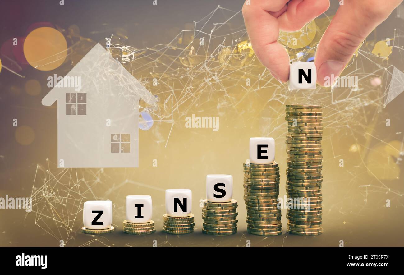 Dice form the German word 'Zinsen' (interest rates) on increasing high stacks of coins. Symbol for increasing interest rates. Stock Photo