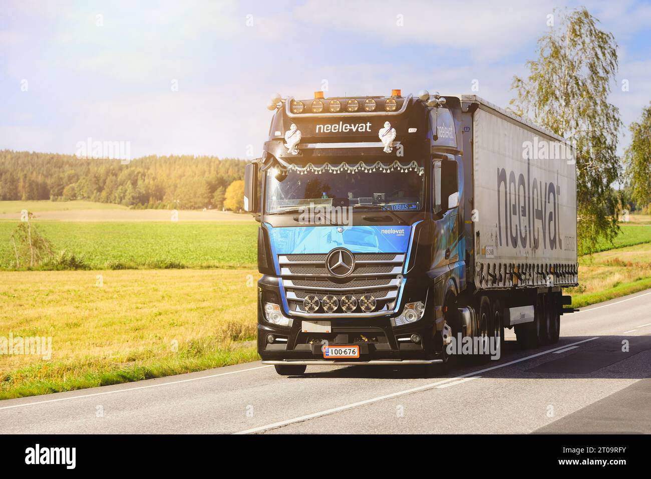 Mercedes-Benz Actros 2853 truck semi trailer Neele-Vat logistics transports goods on highway 52 in autumn sunlight. Salo, Finland. Sept 22, 2023. Stock Photo