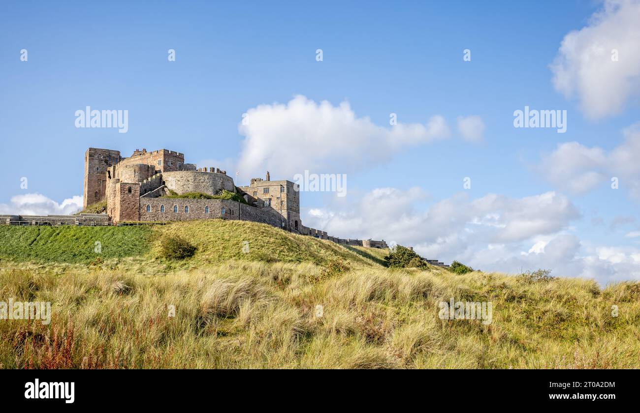 Coastal view of Bamburgh Castle rising from the sand dunes at Bamburgh ...