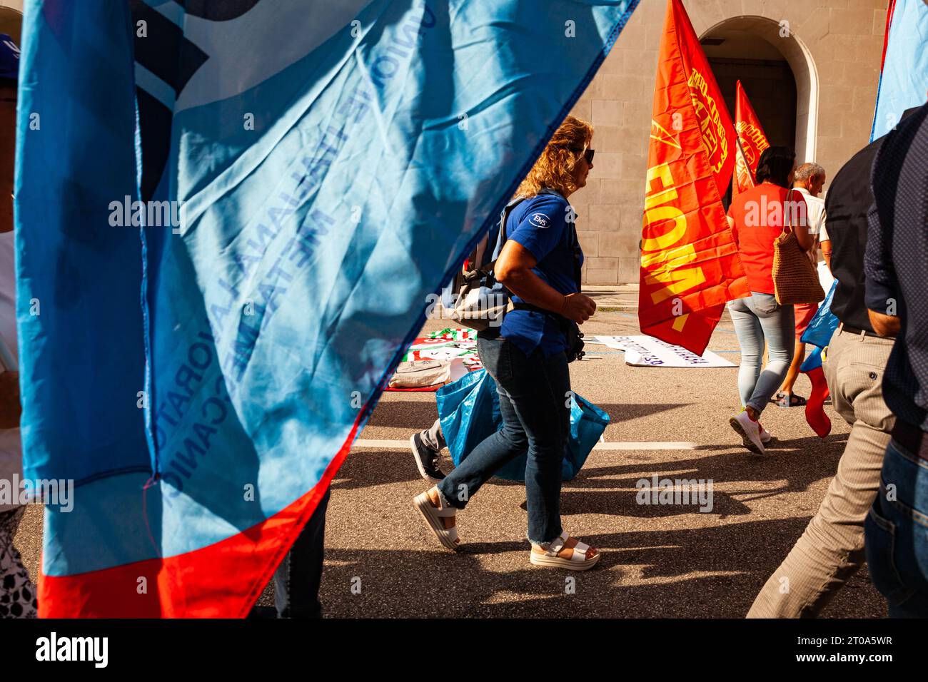 Trieste, Italy - September 03, 2022: Protesters with flags from the Italian Unions UIL and FIOM during the demonstration against the layoffs of worker Stock Photo