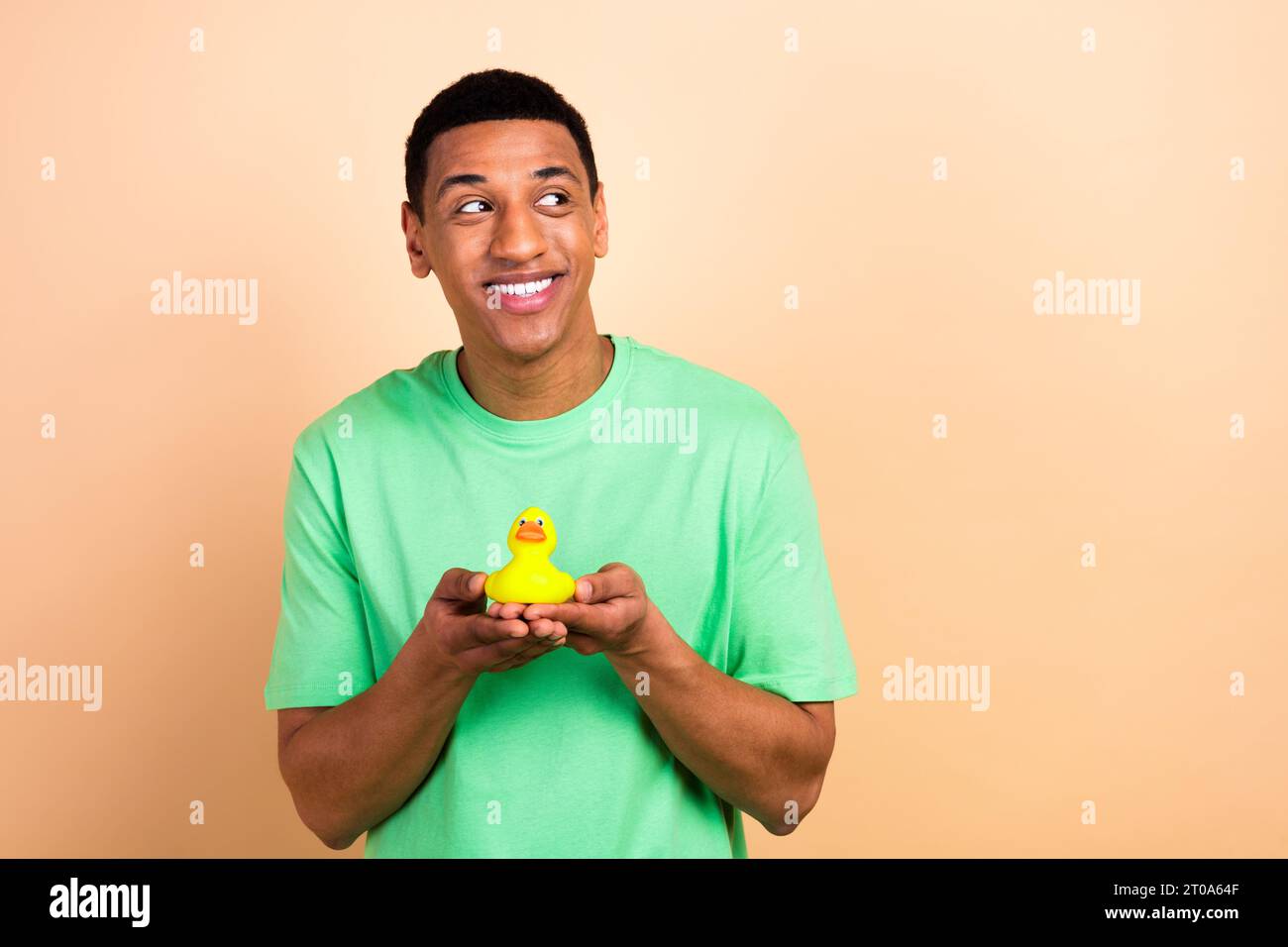 Photo portrait of nice young guy hands hold bathing duck look empty ...