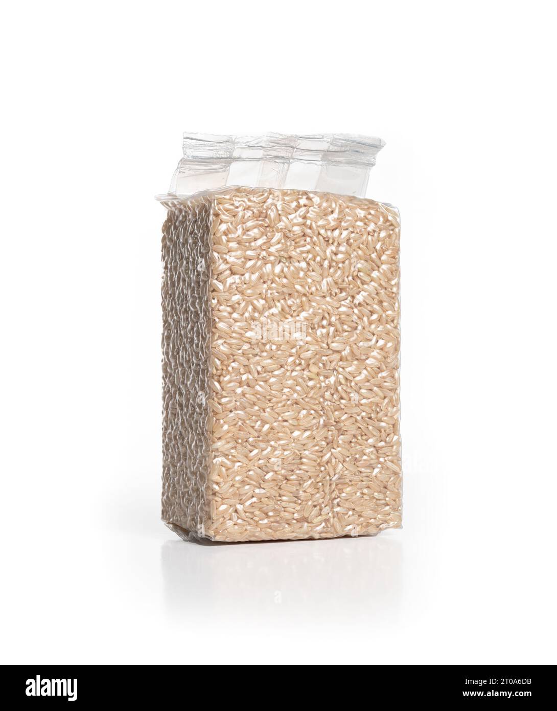 Brown short-grain rice in plastic package. Perspective view of dry and raw rice in store bought vaccume sealed packaging. Stock Photo