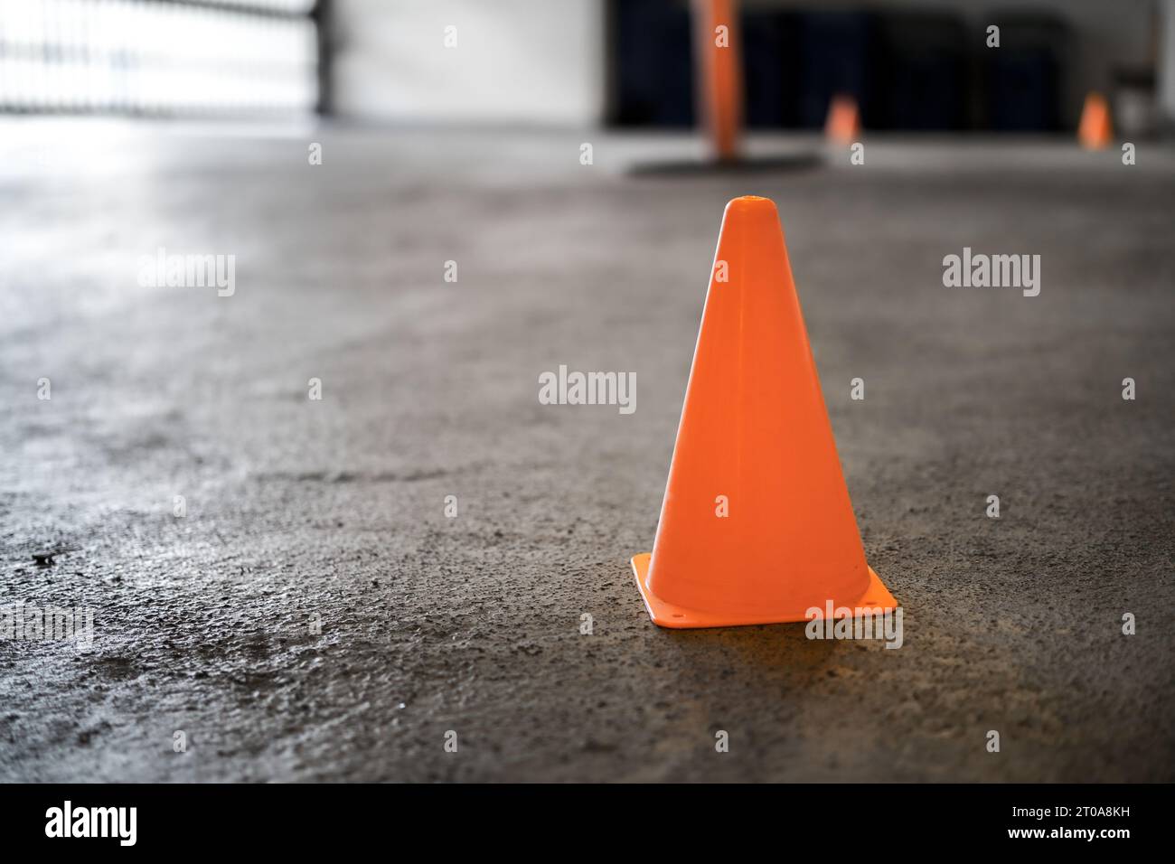 Safety cone on driveway in parking garage while repair work is in