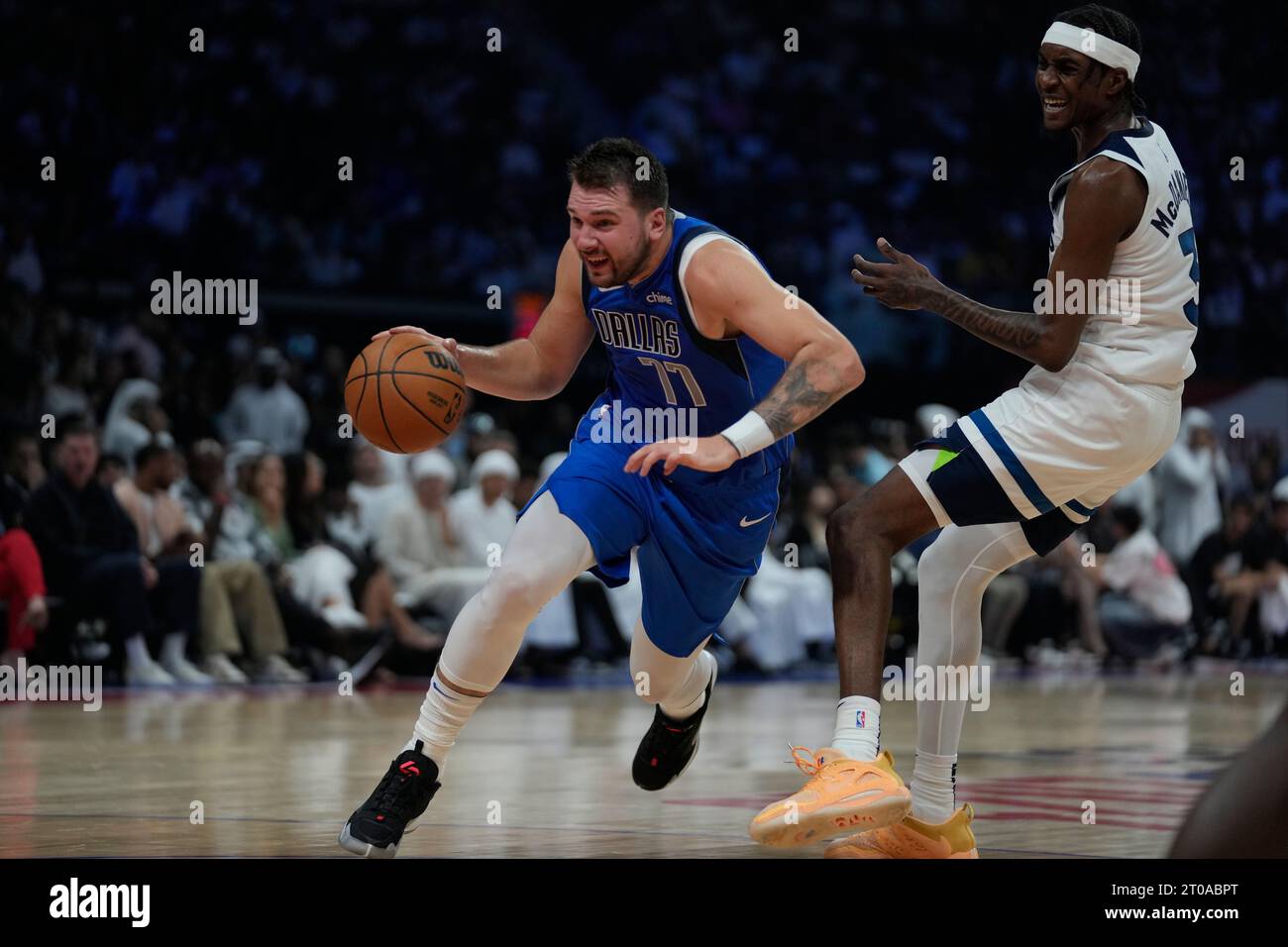 Luka doncic of dallas mavericks drives past jaden mcdaniels of