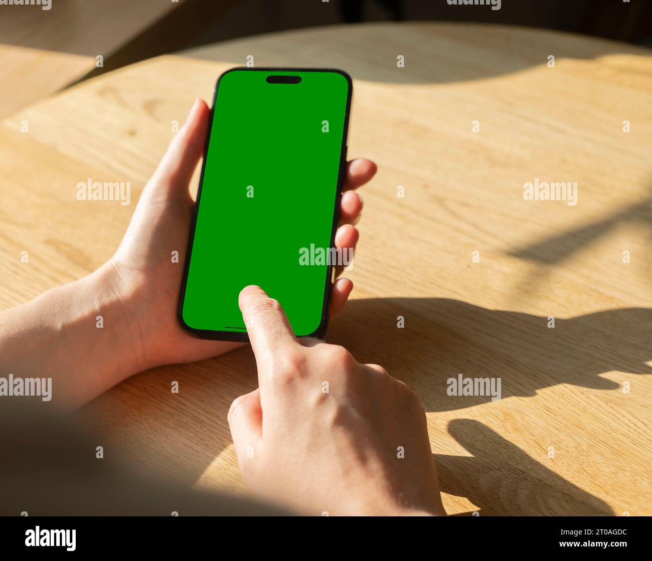 Berlin, Germany September 16 2023 Hand holding mobile phone screen mockup, POV, tapping with finger Stock Photo