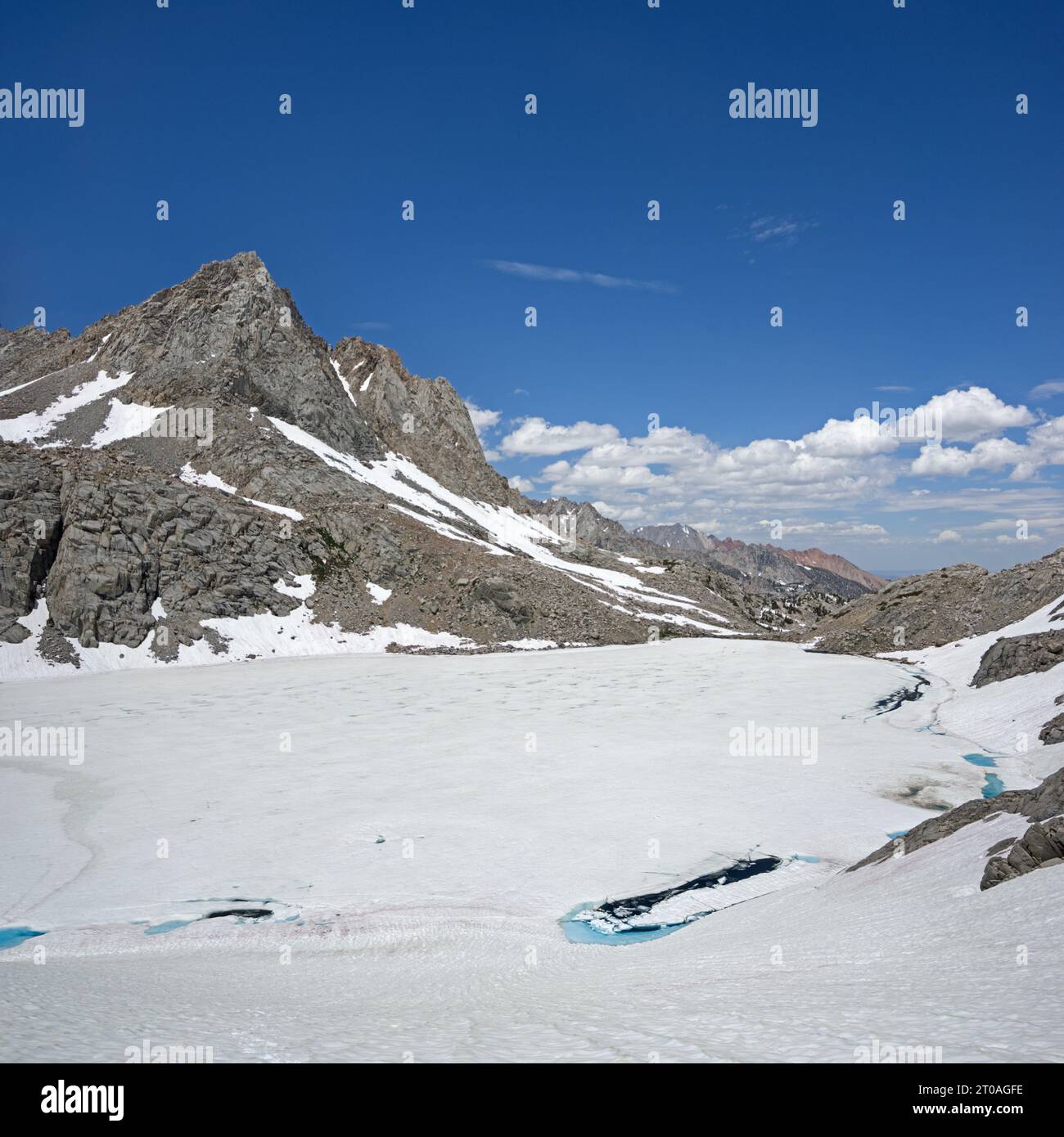 Picture Peak and a mostly frozen Echo Lake in the John Muir Wilderness of the Sierra Nevada Mountains in July of a high snow year Stock Photo
