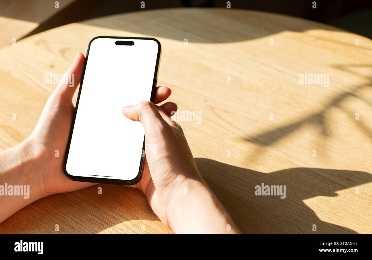 Berlin, Germany September 16 2023 Hand holding smartphone screen mock up, POV, tapping, clocking with finger Stock Photo