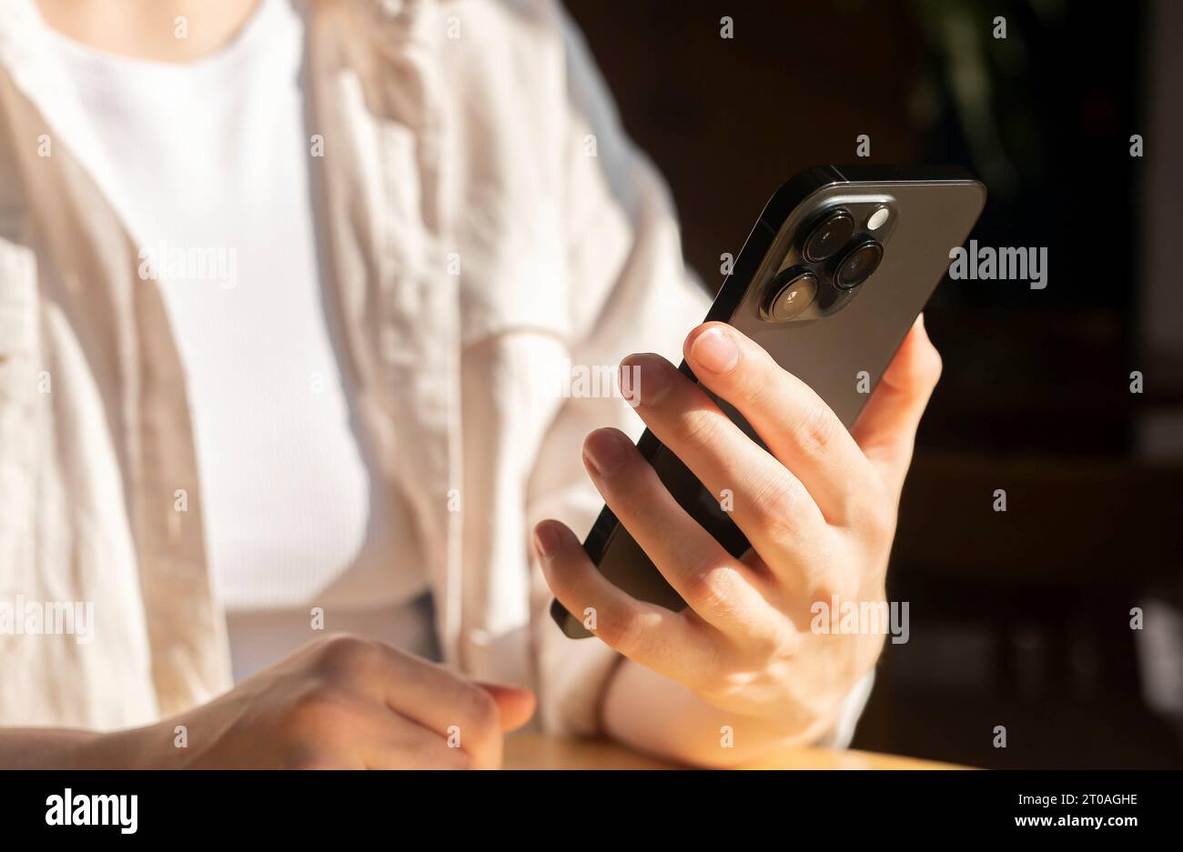 Berlin, Germany September 16 2023 Hands with smart phone. Holding mobile device, iphone, reading news, social media, network Stock Photo