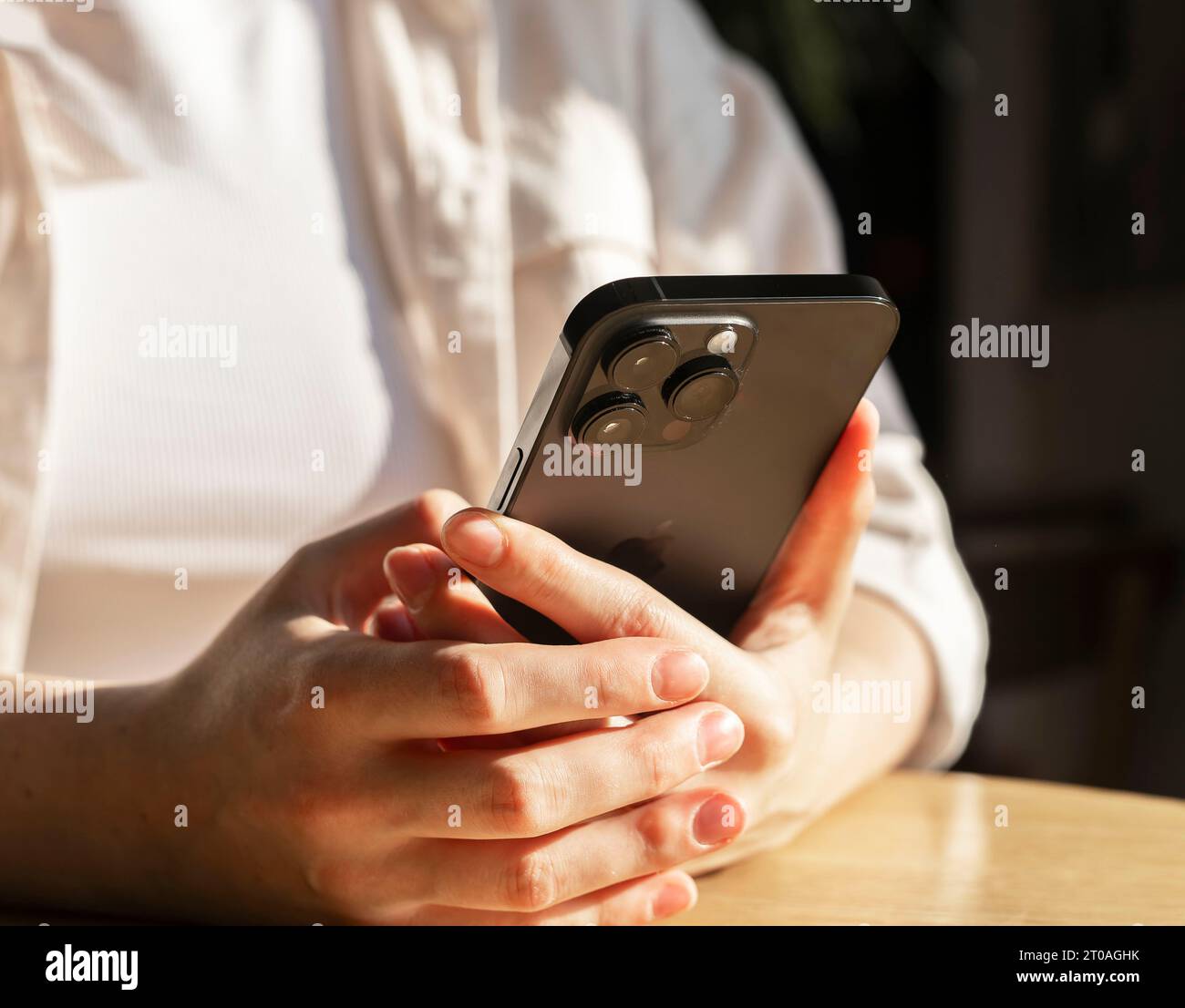 Berlin, Germany September 16 2023 Hands with smart phone. Using cellphone, reading news, social media, network Stock Photo