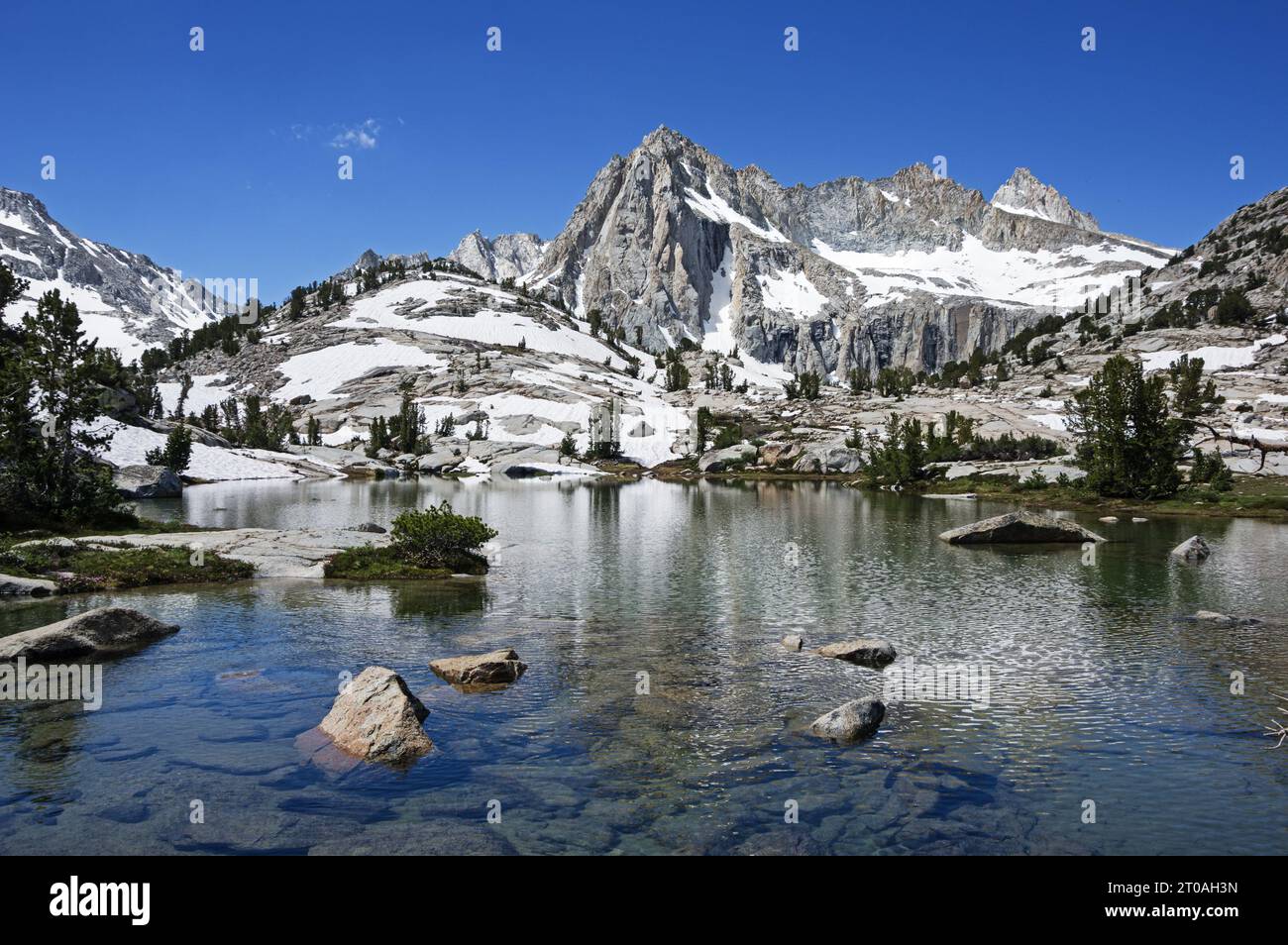 Picture Peak and Sailor Lake in the John Muir Wilderness of the eastern Sierra Nevada Mountains of California with snow on the ground in July Stock Photo
