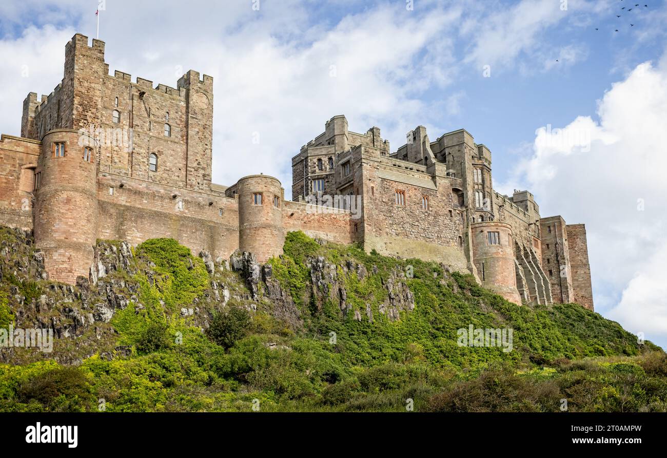 Town side view of Bamburgh Castle ramparts and battlements in Bamburgh ...