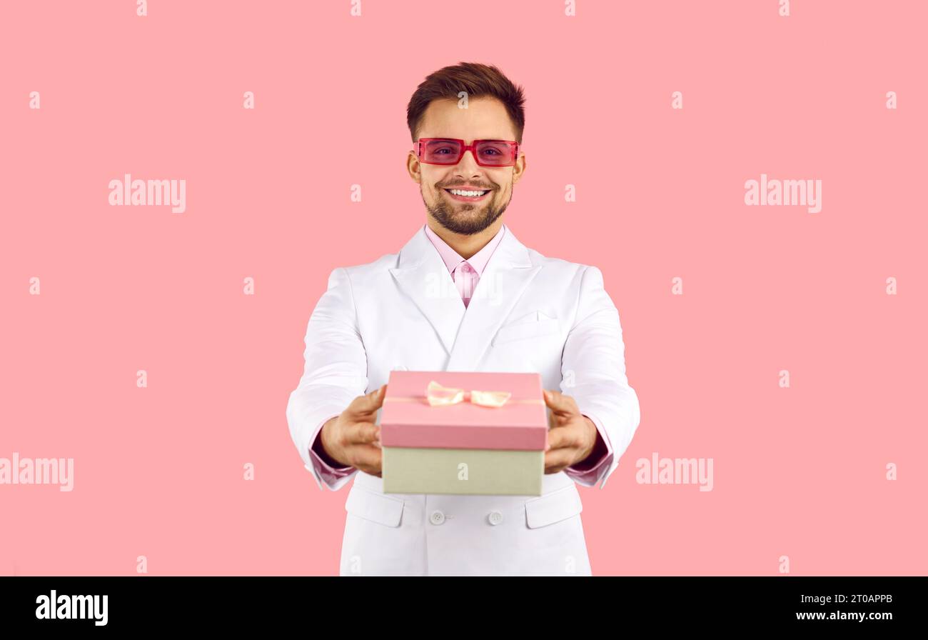 Smiling man in suit congratulate with gift box Stock Photo