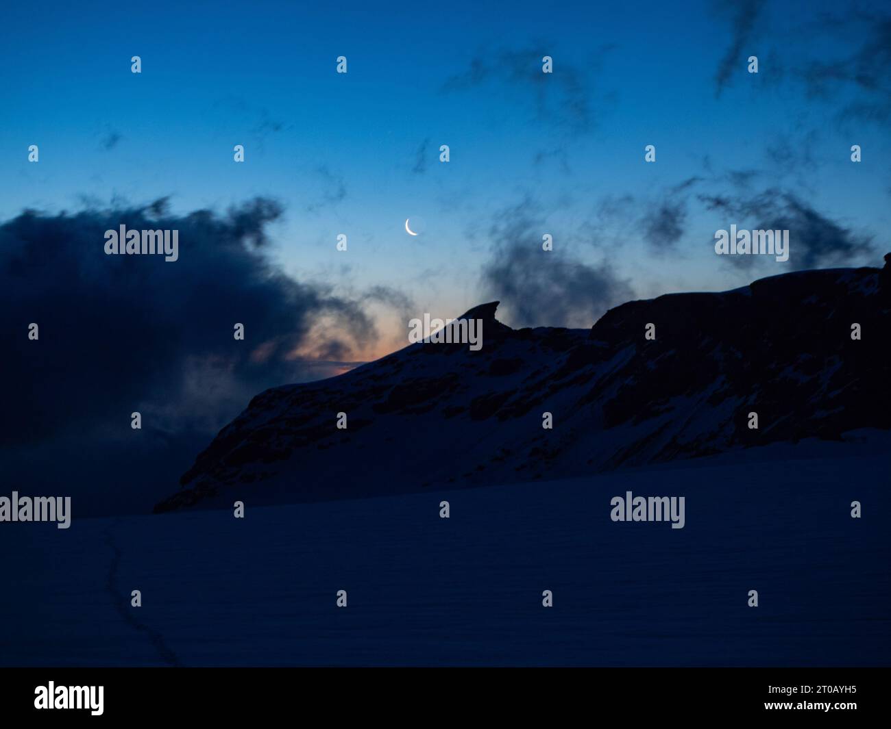 Saas-Fee, Switzerland - June 16th 2023: In the early morning on Allalin Glaciert shortly before sunrise Stock Photo