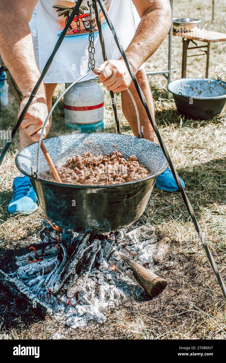 stew cooking in a cauldron, cooking goulash in a cauldron Stock Photo