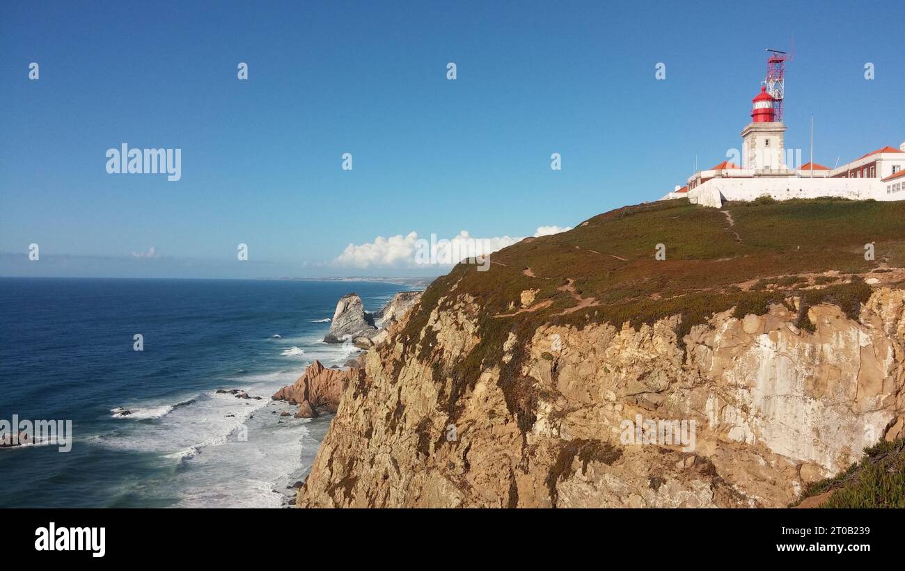 A majestic lighthouse standing atop a large cliff, overlooking the ...