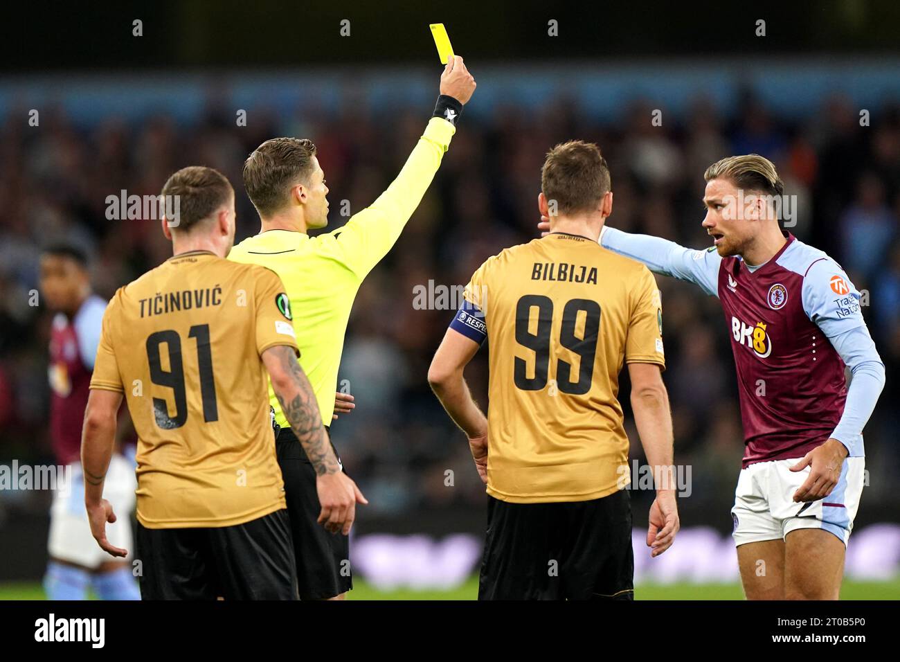 Aston Villa's Matty Cash (right) is shown a yellow card by referee Urs Schnyder during the UEFA Europa Conference League Group E match at Villa Park, Birmingham. Picture date: Thursday October 5, 2023. Stock Photo