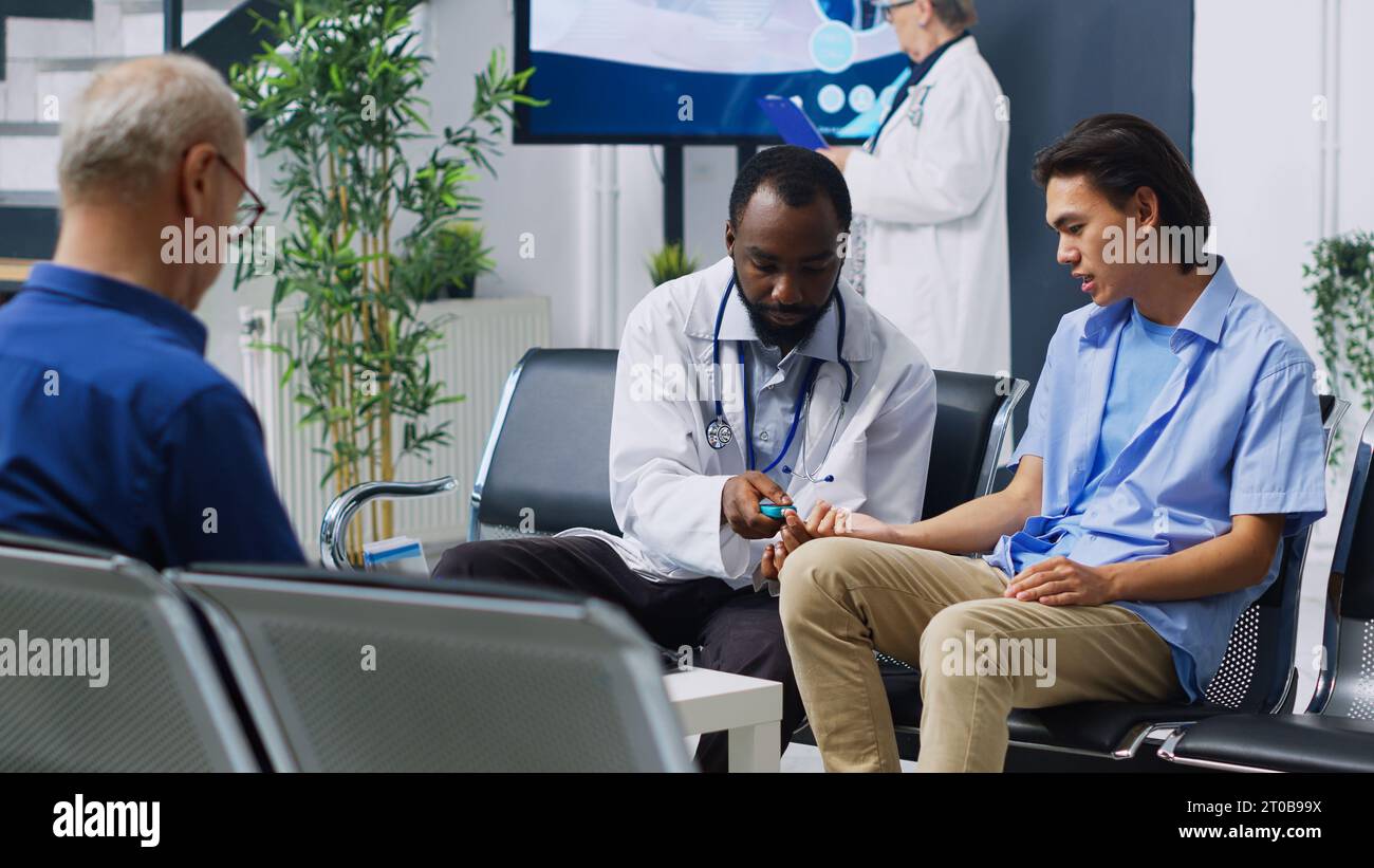 Physician using medical to check asian man blood sample